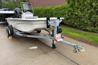 2025 Mako Pro Skiff 13 CC boat on trailer, parked on driveway.