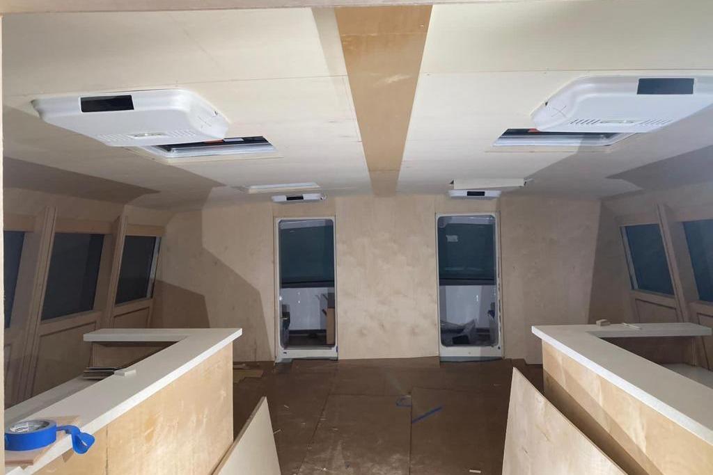Interior of a 2003 Gold Coast fast ferry under construction, featuring unfinished wood paneling.