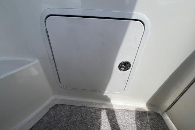 Storage compartment on a 2003 Sea Ray 260 Sundancer boat interior.