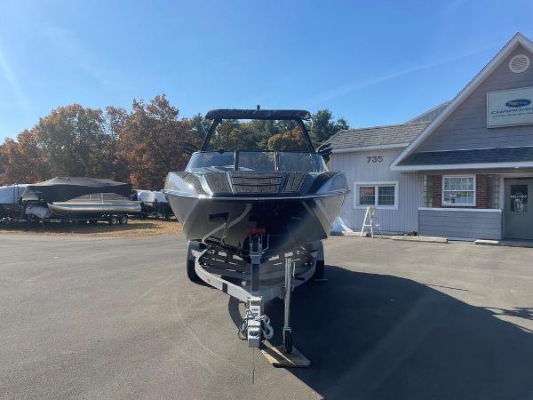 2025 Moomba Mondo boat on trailer outside dealership, sunny day.