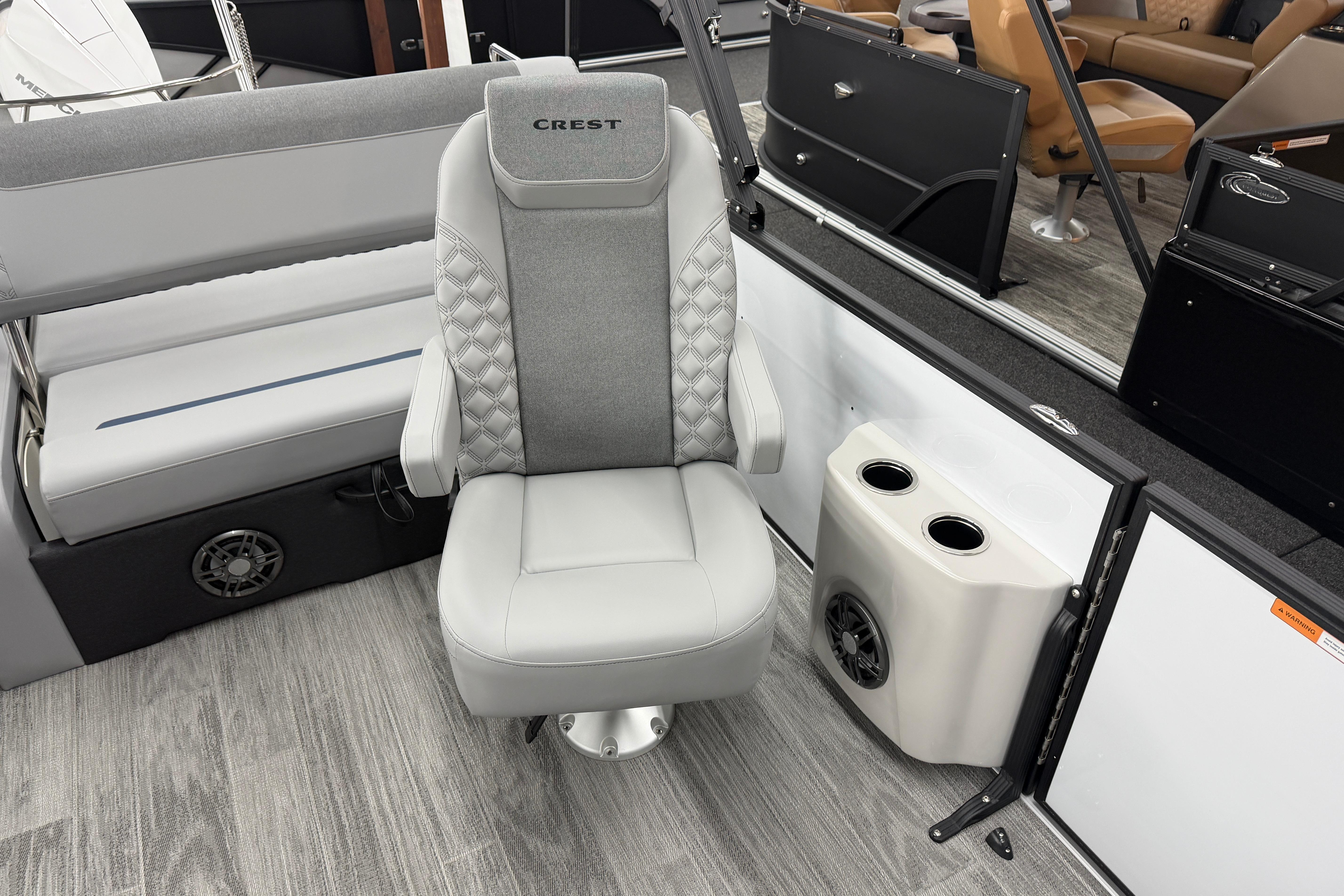 Luxury seating on 2026 Crest Conquest 250 SLSC boat with cup holders and speaker.