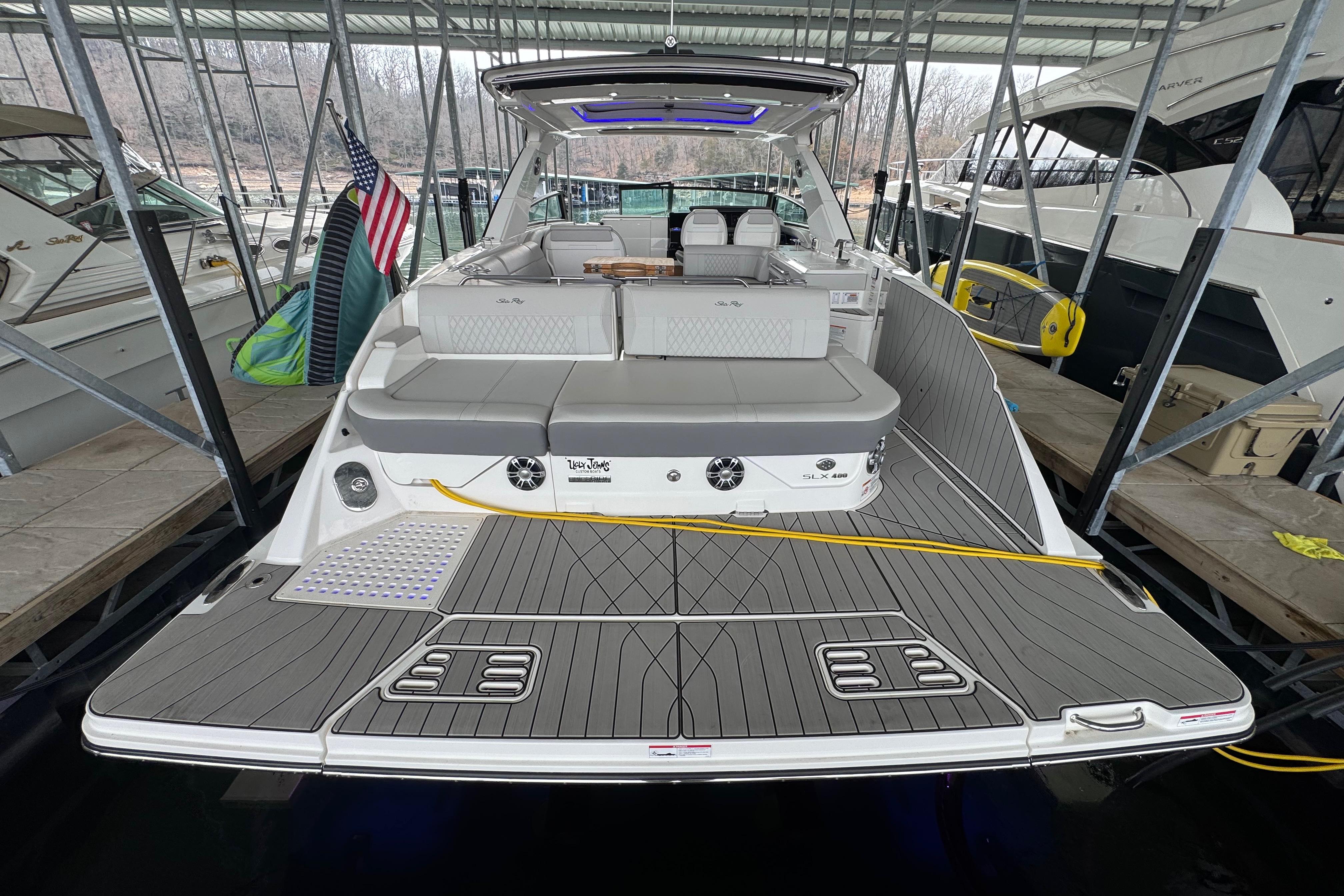 2025 Sea Ray SLX 400 luxury boat docked, featuring spacious deck and modern design.