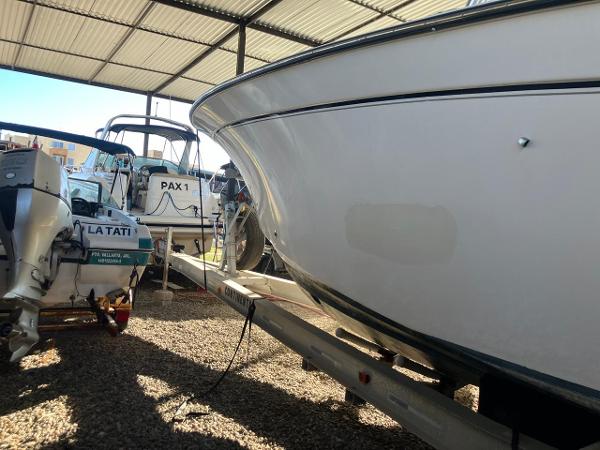 2006 Grady-White Bimini 306 boat in storage, alongside other vessels.