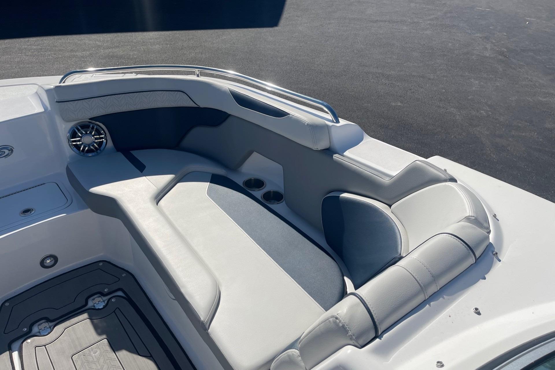 2023 Hurricane SunDeck 2400 OB boat interior with cushioned seating and cup holders.
