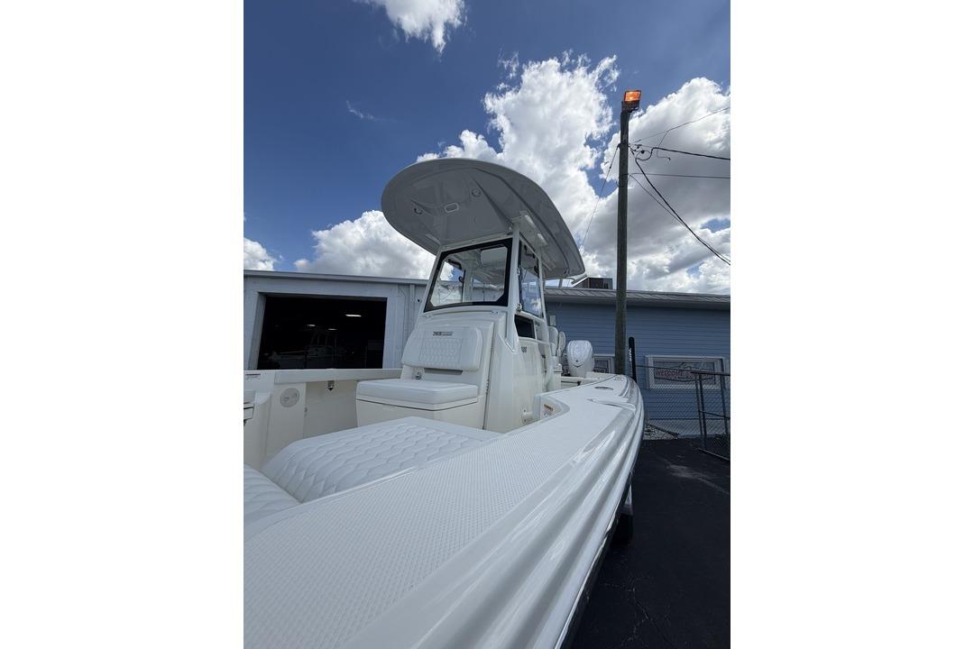 2026 Pathfinder 2800 Hybrid boat with T-top under a cloudy sky.