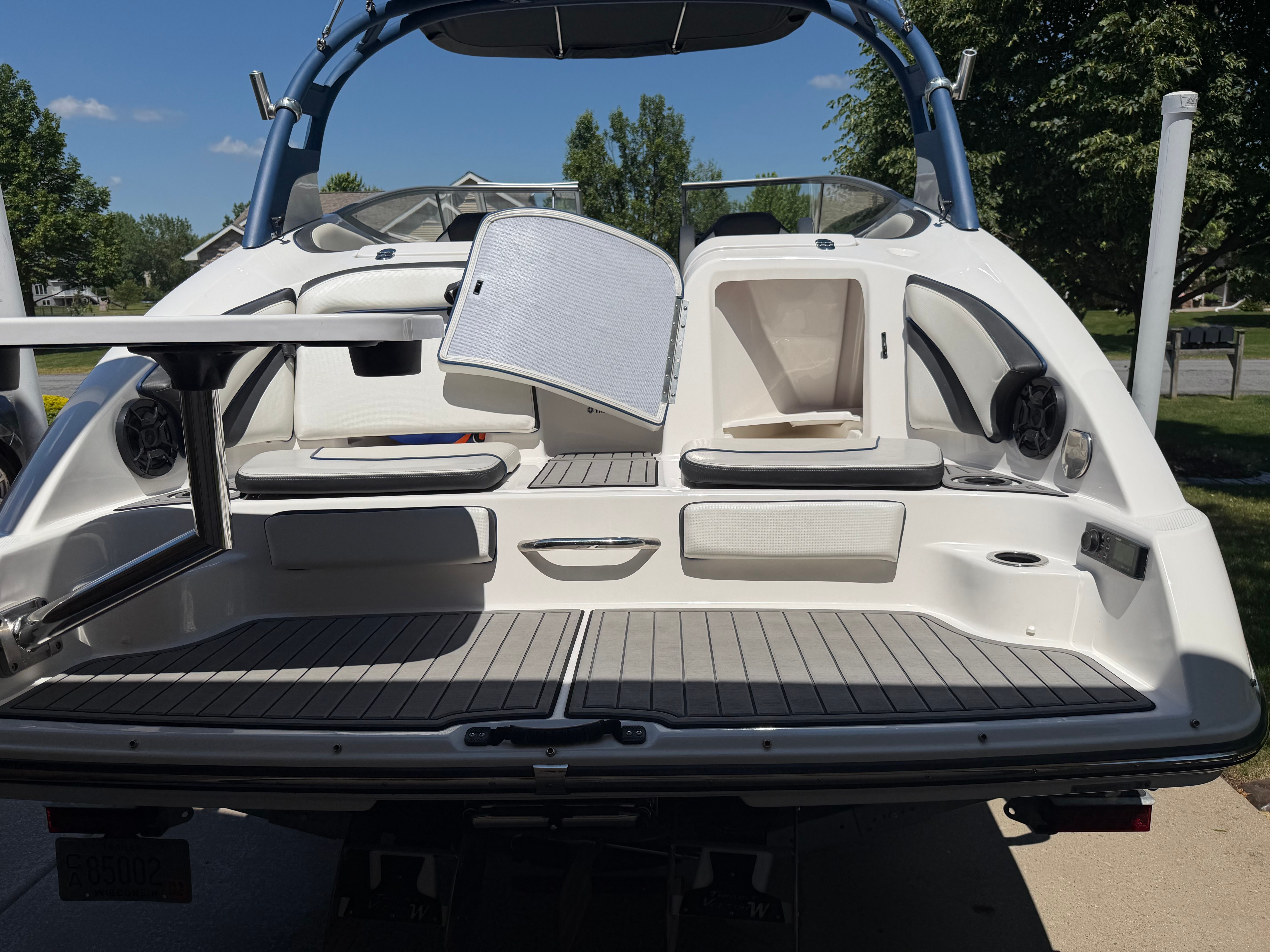 The image shows the stern of a 2018 Yamaha 242 Limited S boat with seating area and speakers.