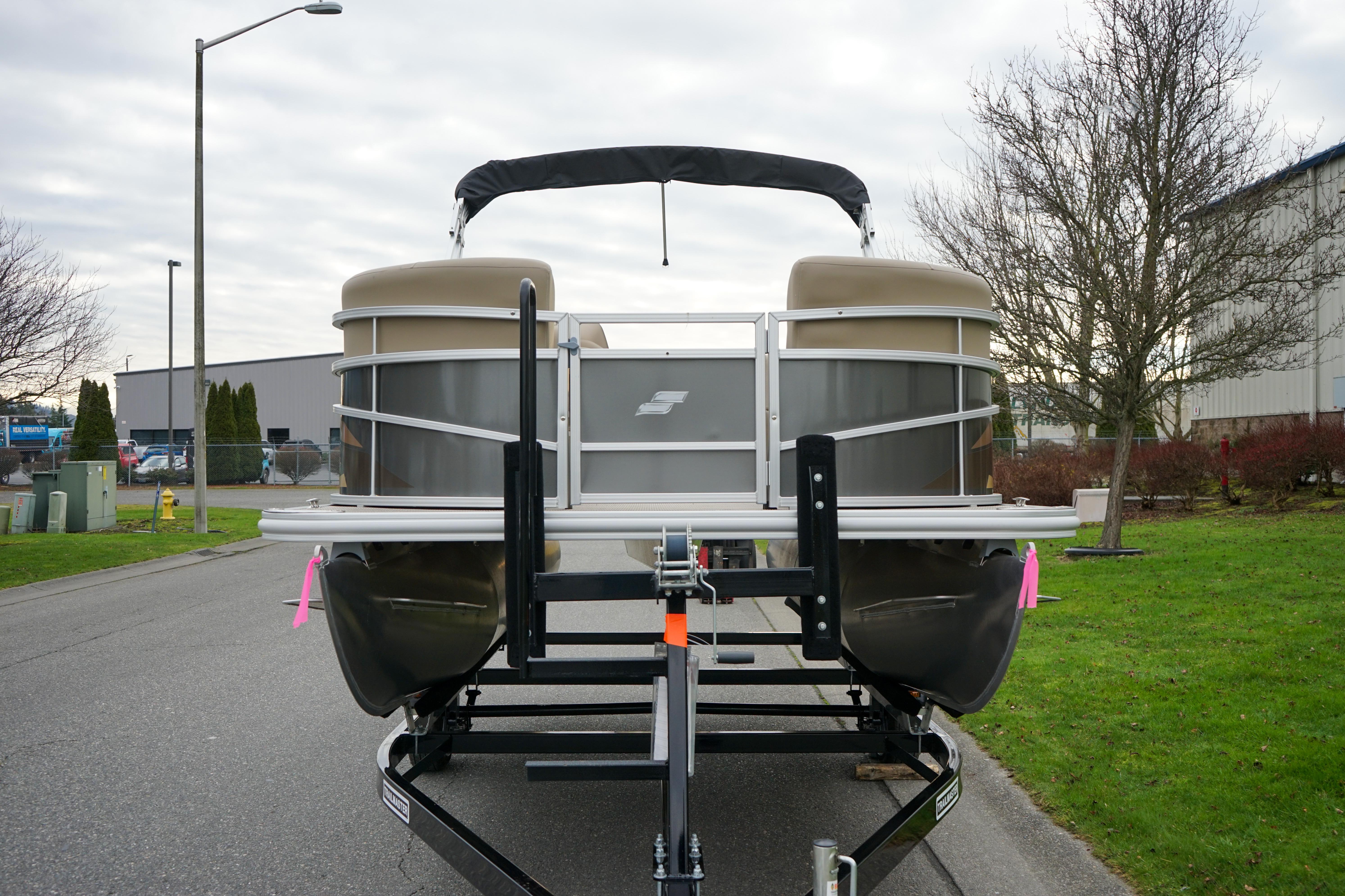 2025 Starcraft LX16R pontoon boat on trailer, parked on a street.