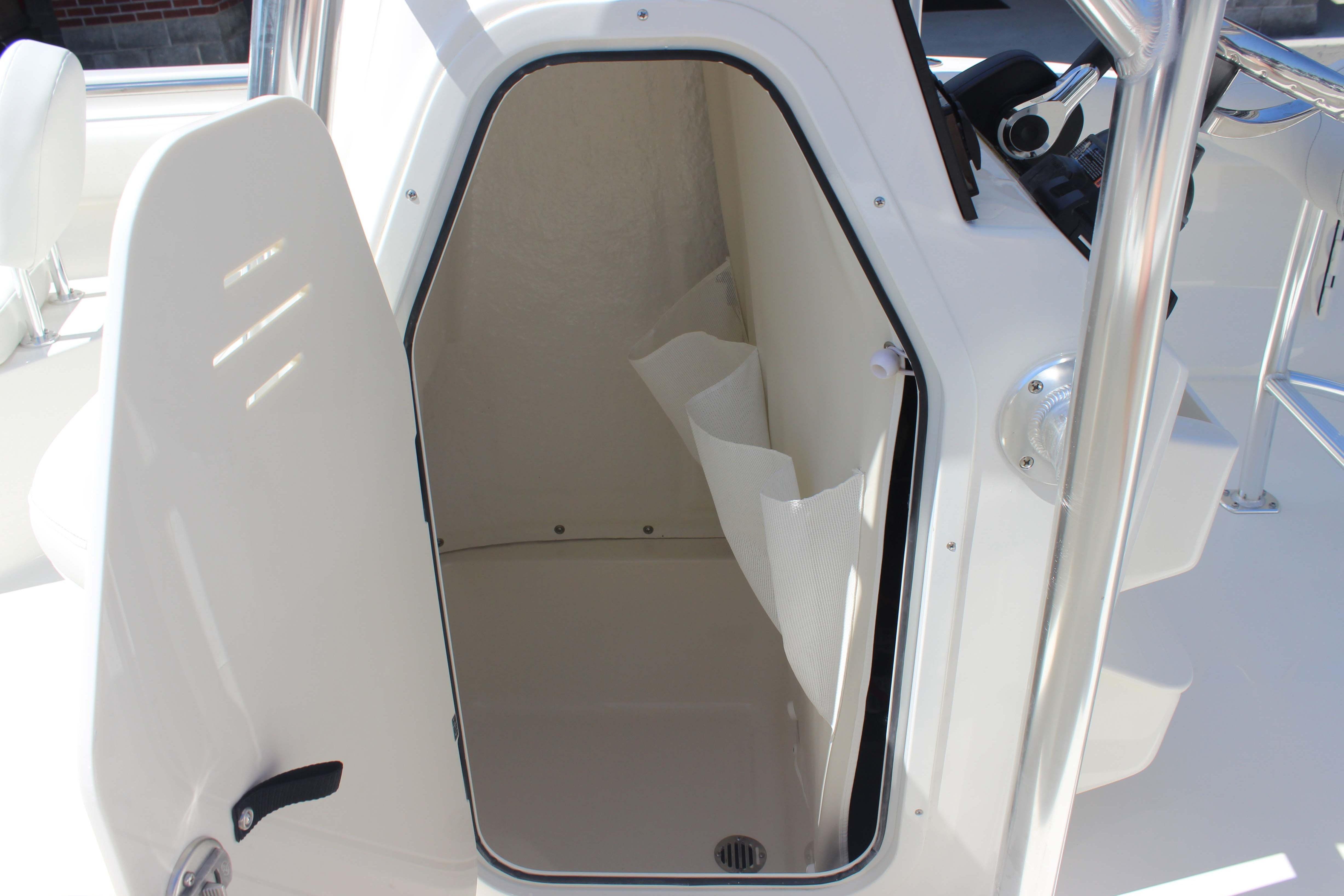 2026 Key West 203 FS boat interior storage compartment with open door.