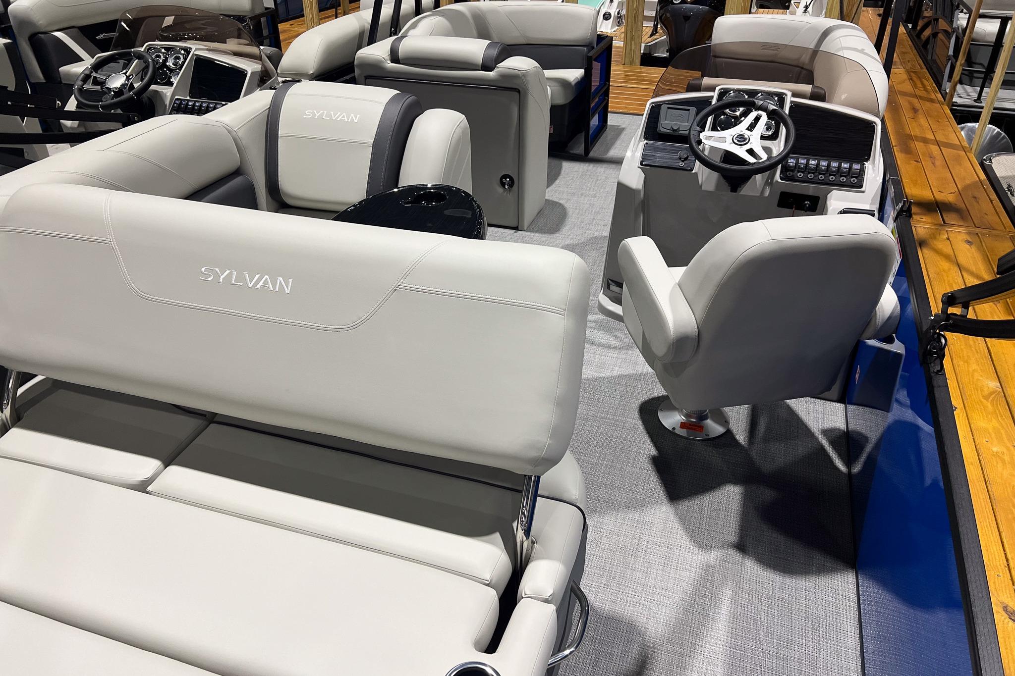 2026 Sylvan Mirage 822 CLZ boat interior with plush seating and modern dashboard.