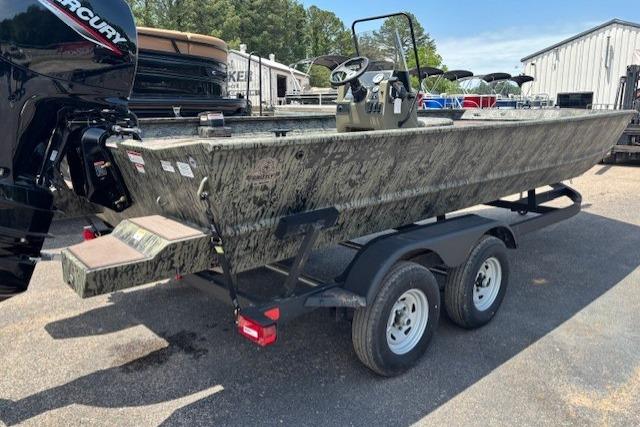 2026 Tracker Grizzly 2072 CC boat on trailer, parked outdoors.