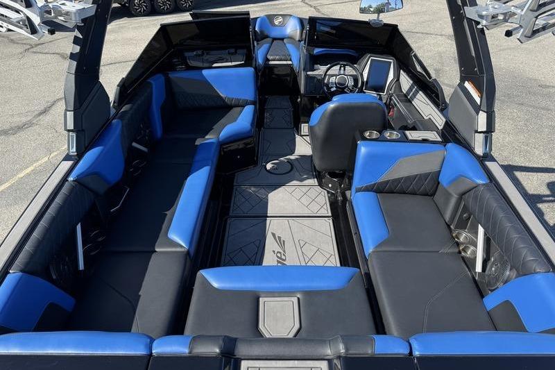 2022 Tigé Z3 boat interior with blue and black seating, modern dashboard, and spacious layout.
