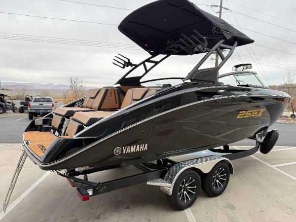 2025 Yamaha Boats 255XD on trailer, sleek black design, modern features, outdoor setting.