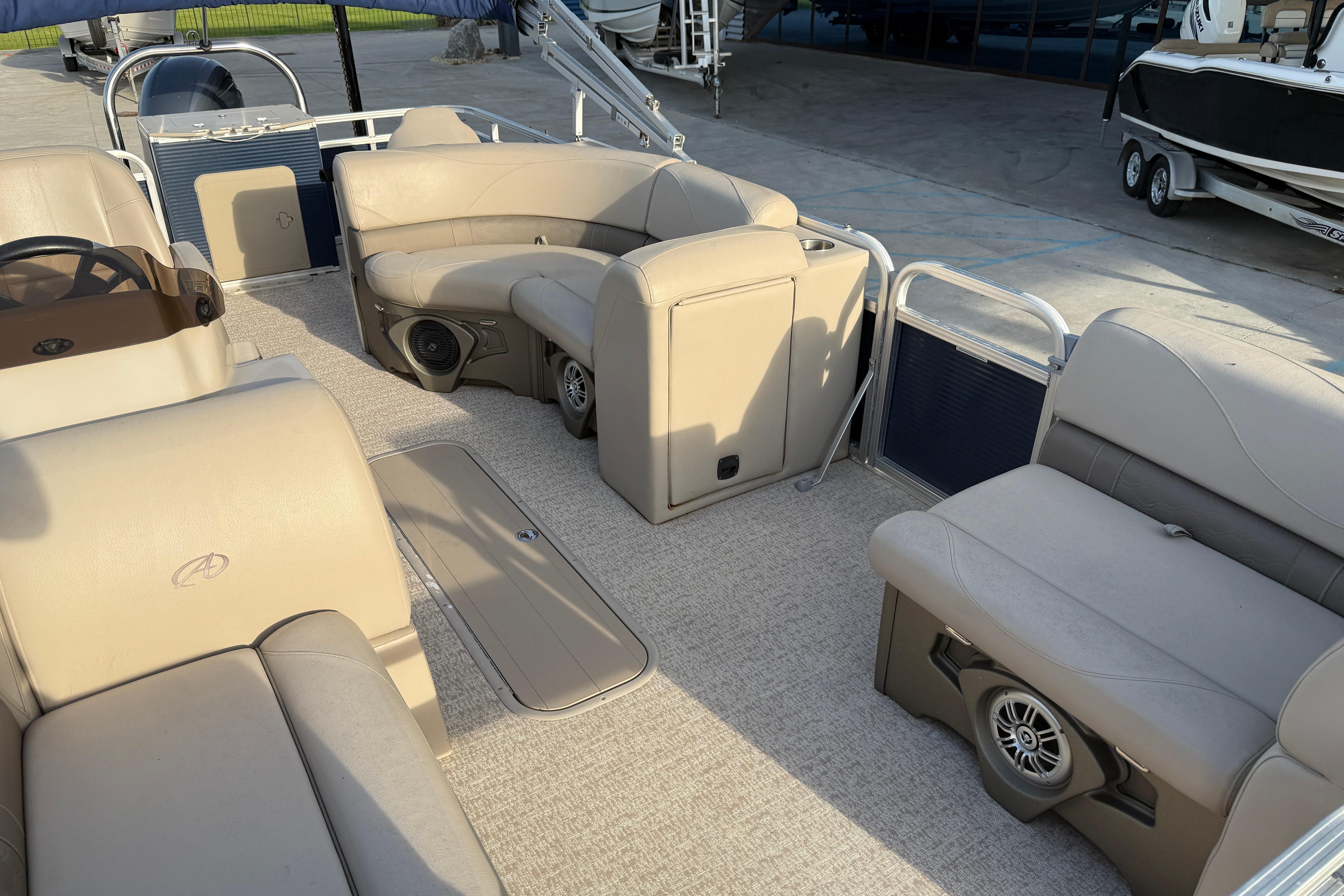 2019 Avalon Venture Fish N Cruise 20' pontoon boat interior with beige seating and speakers.