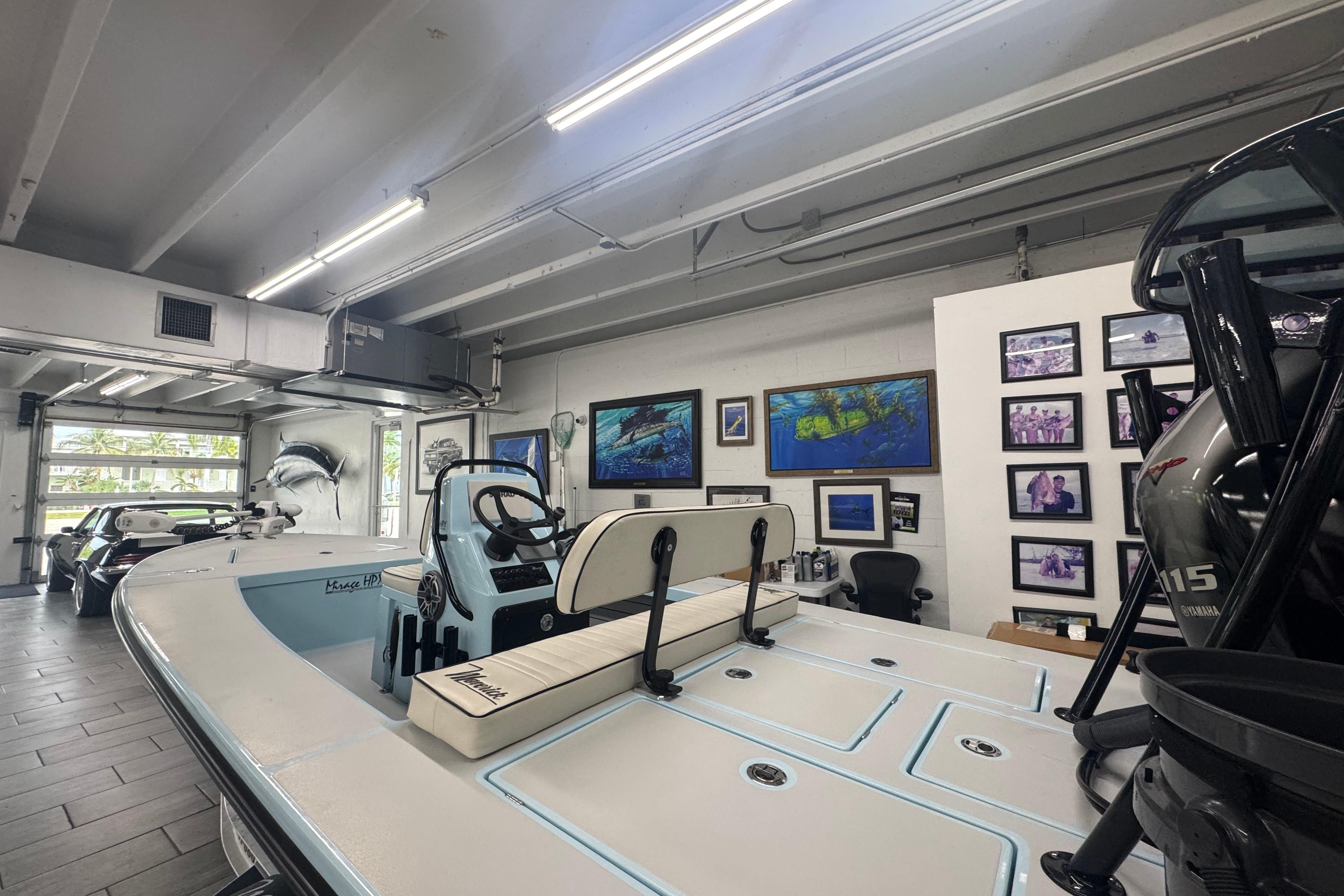 2020 Maverick Mirage 18 HPX-V boat in a showroom with framed artwork on walls.