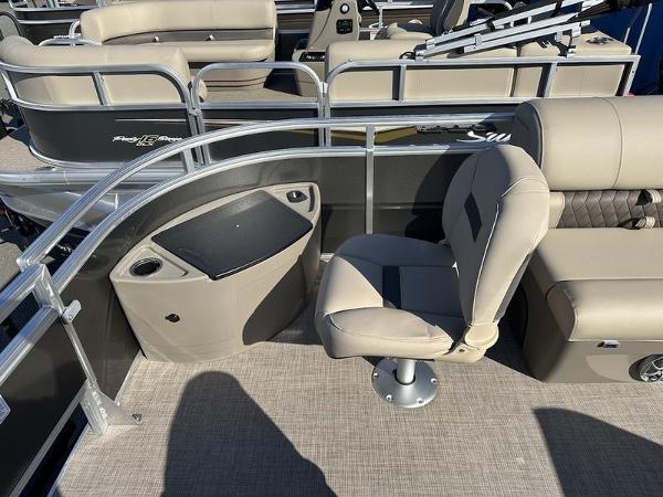 2025 Sun Tracker FB 20 DLX pontoon boat interior with beige seating and railing.