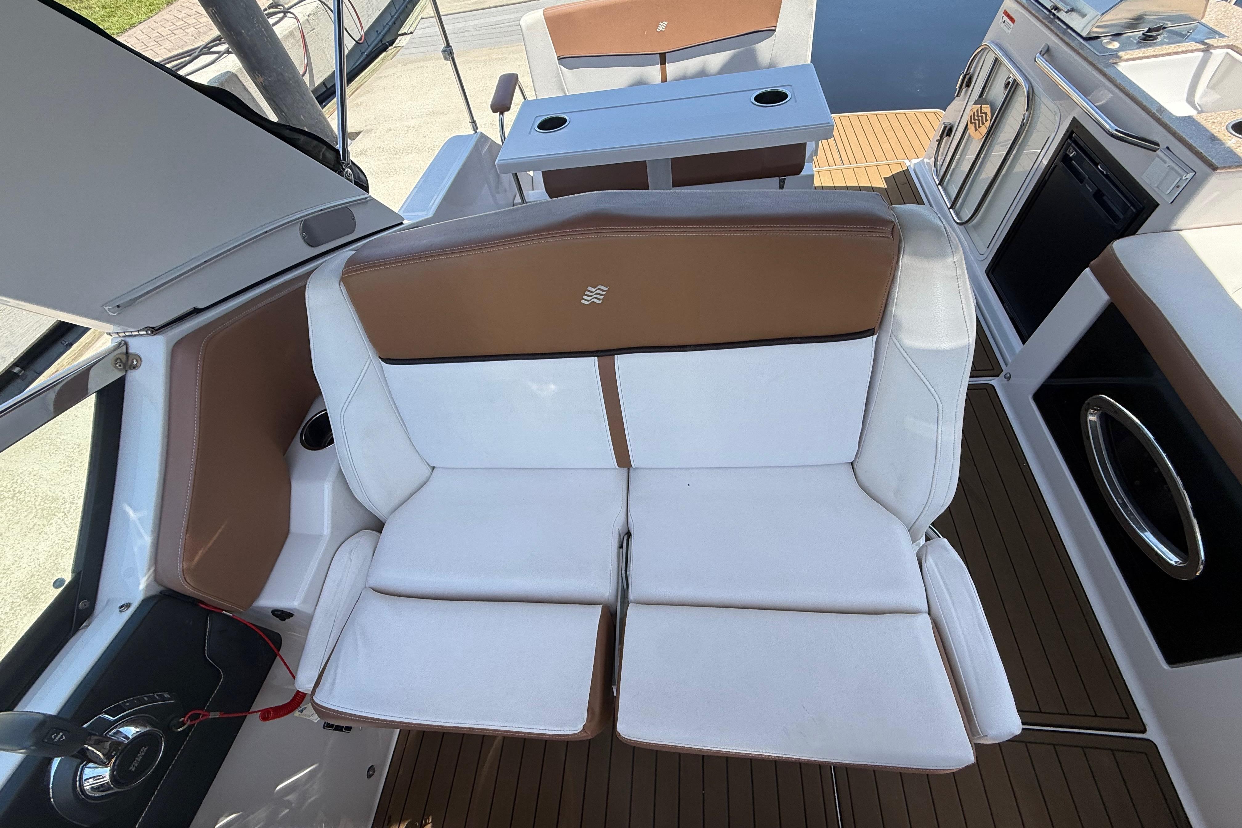 2017 Four Winns V275 boat interior with white and brown seating, modern design.