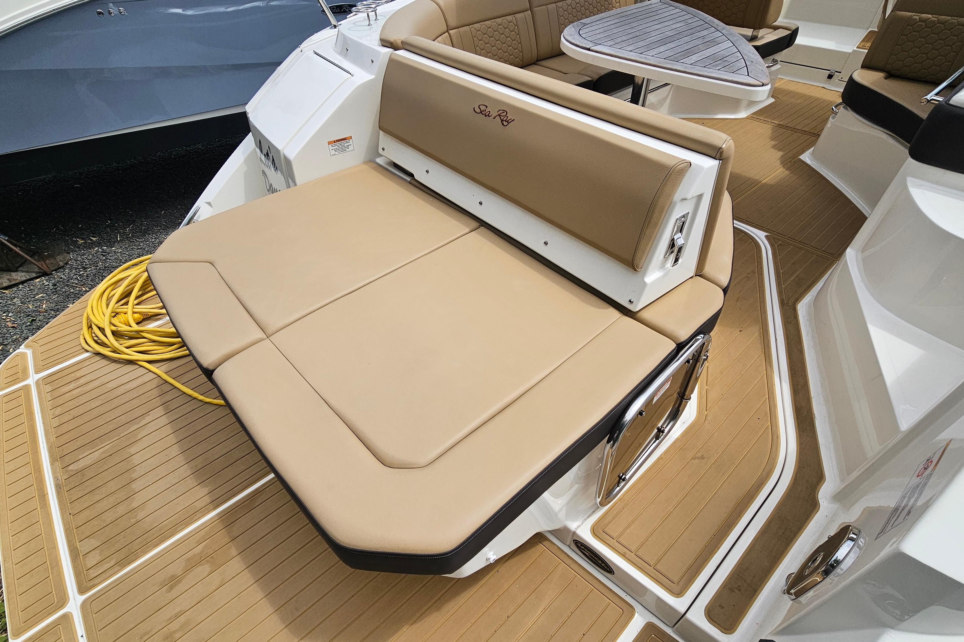 2023 Sea Ray Sundancer 320 boat deck with tan seating and table.