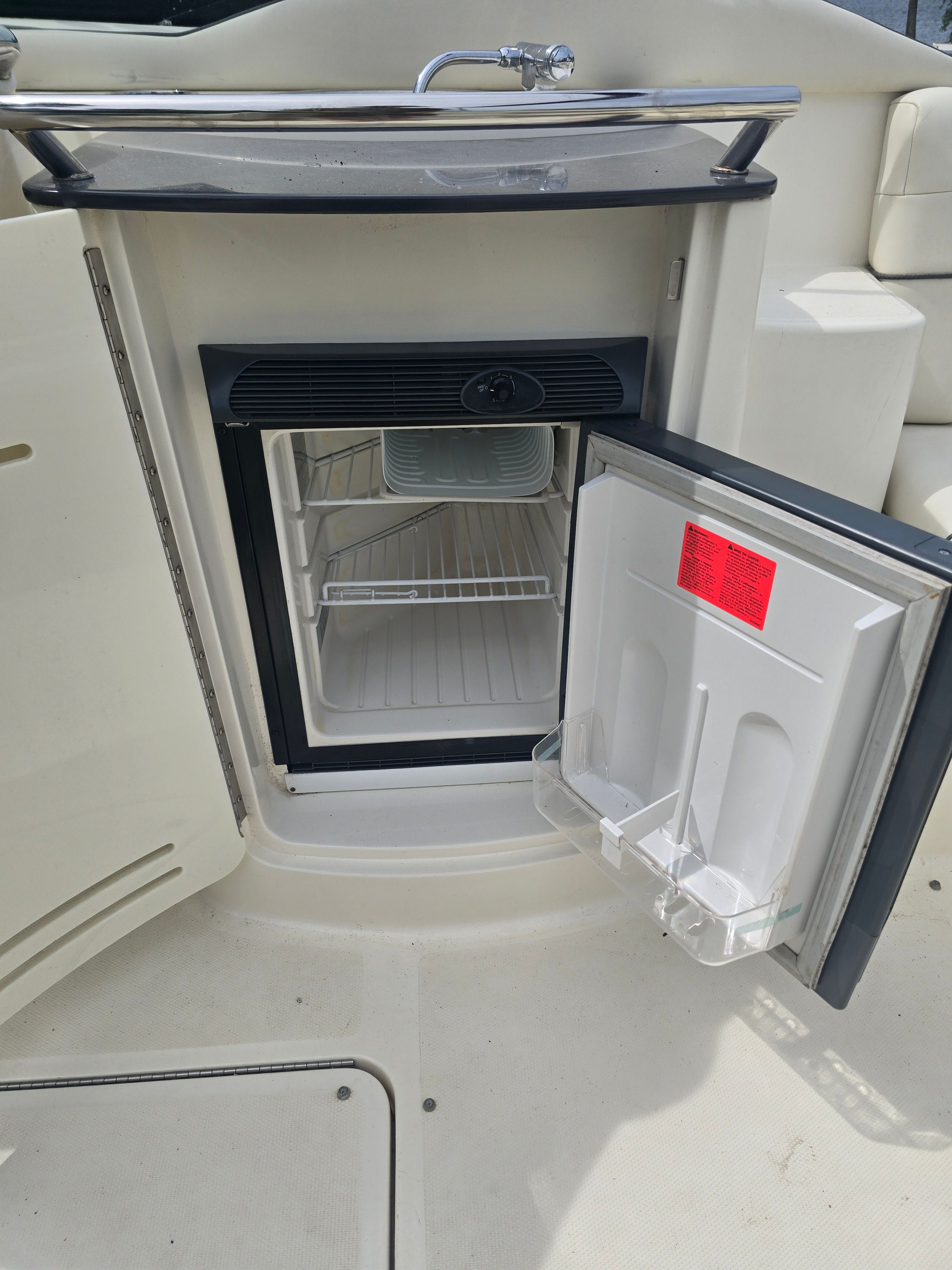 Open fridge on a 2007 Sea Ray 270 Select EX boat.
