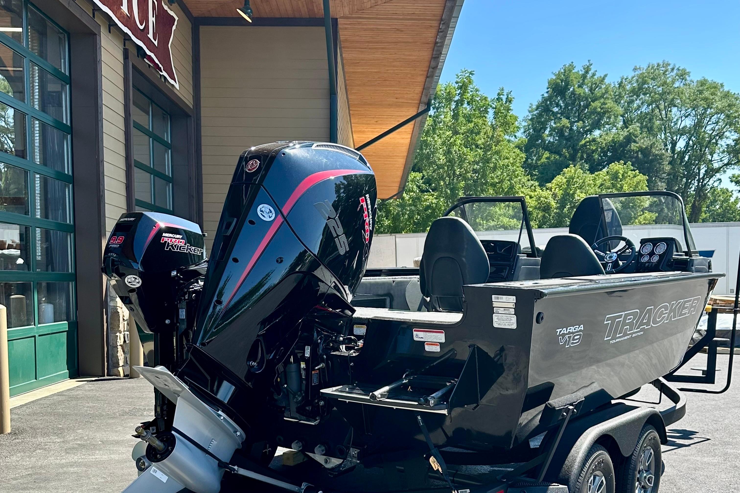 2026 Tracker Targa V-19 WT boat with powerful Mercury outboard engines, parked outdoors.