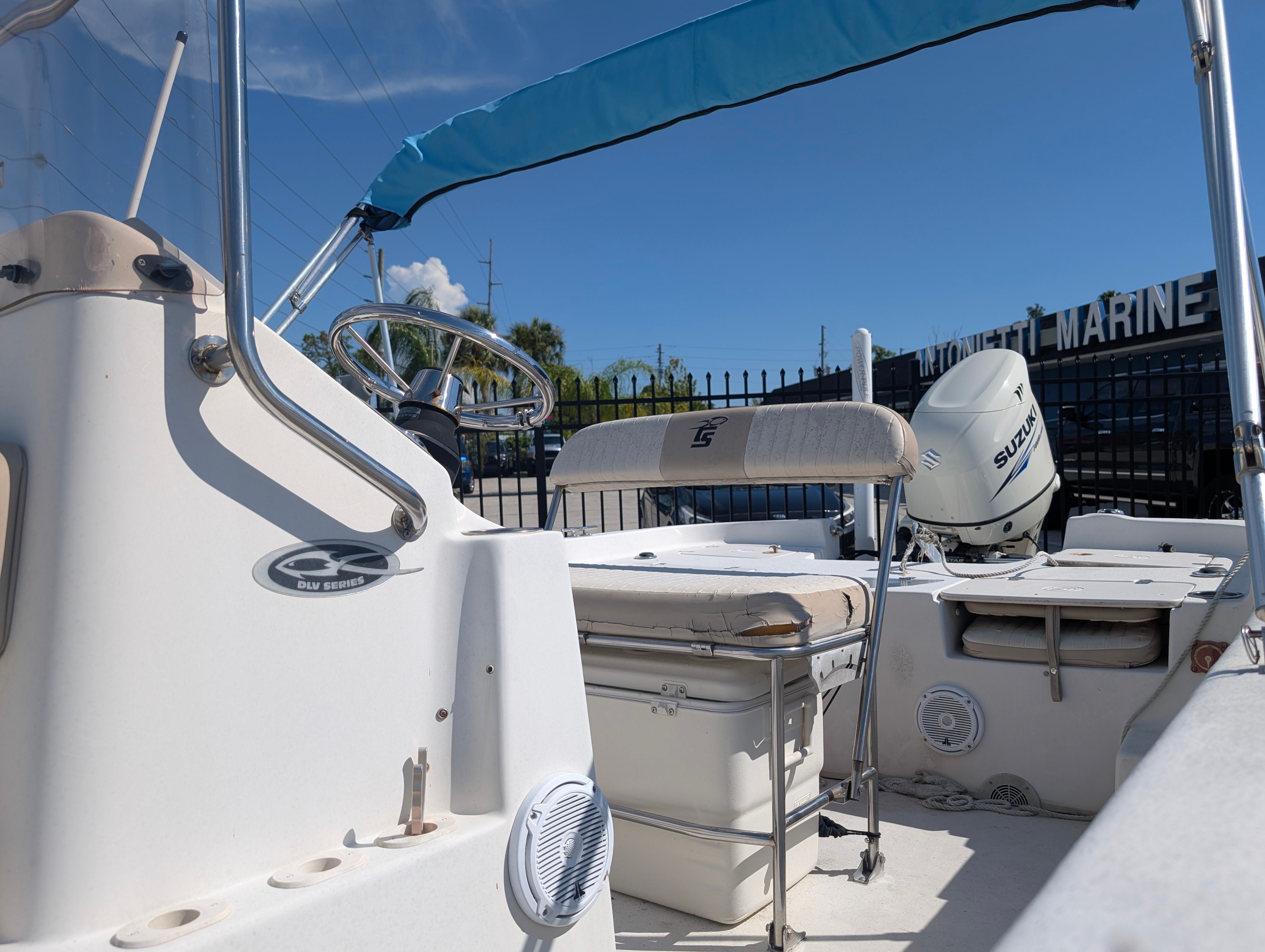 The image shows the cockpit of a 2016 Carolina Skiff 198 DLV with helm and seating.