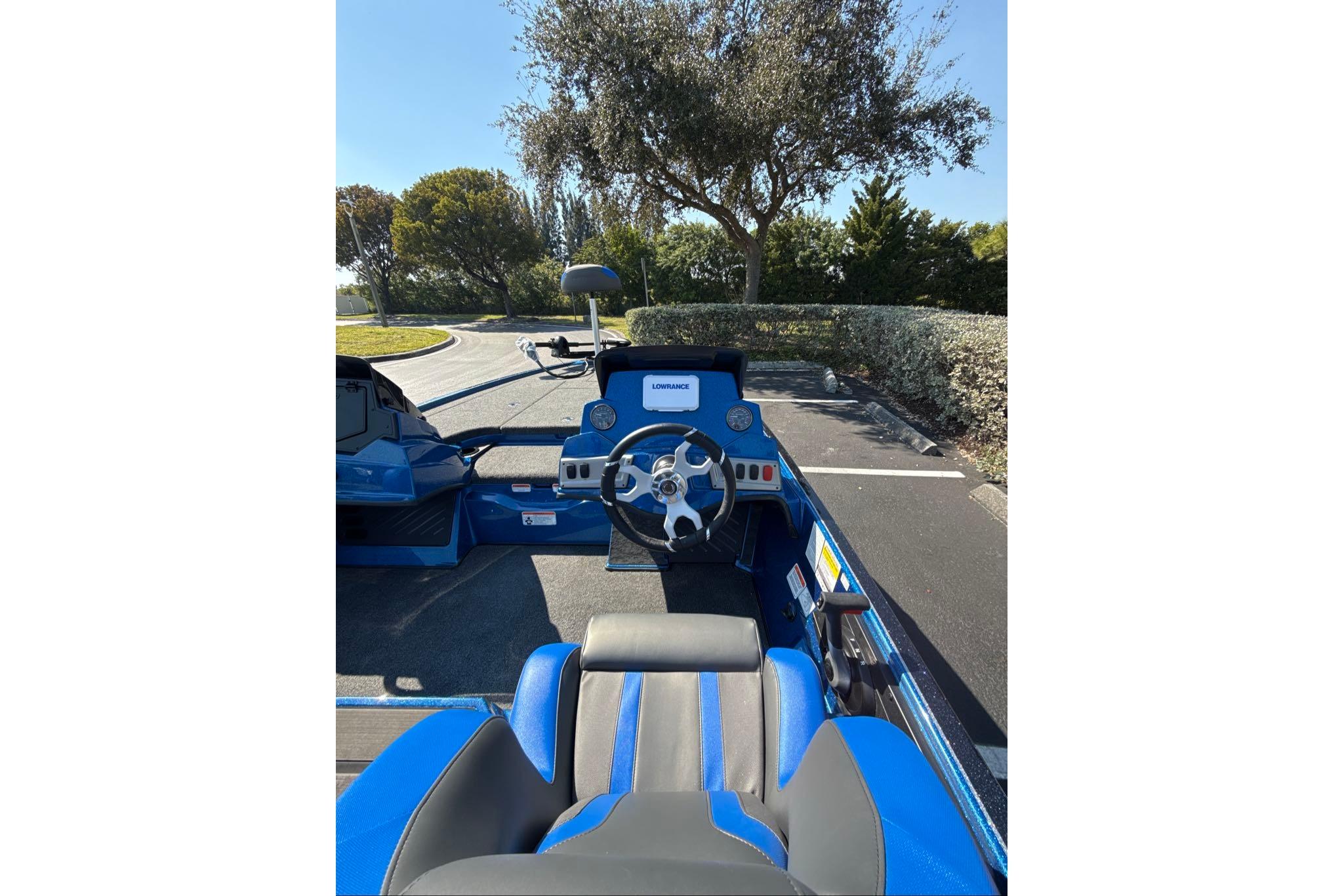 2026 Nitro Z19 XL boat interior with steering wheel and dashboard, parked outdoors.