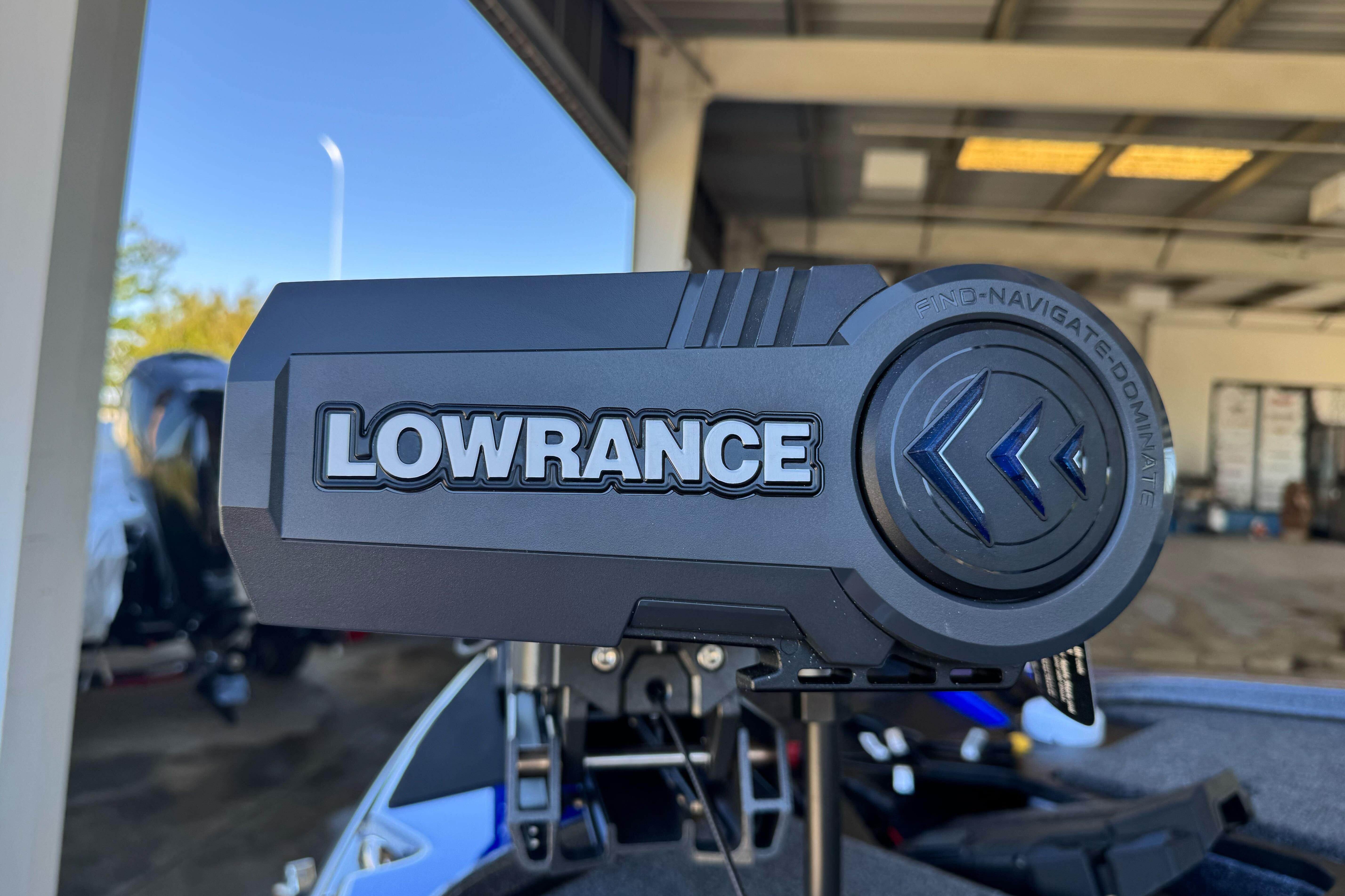 Lowrance device on 2026 Triton 21XP Patriot boat in a garage setting.