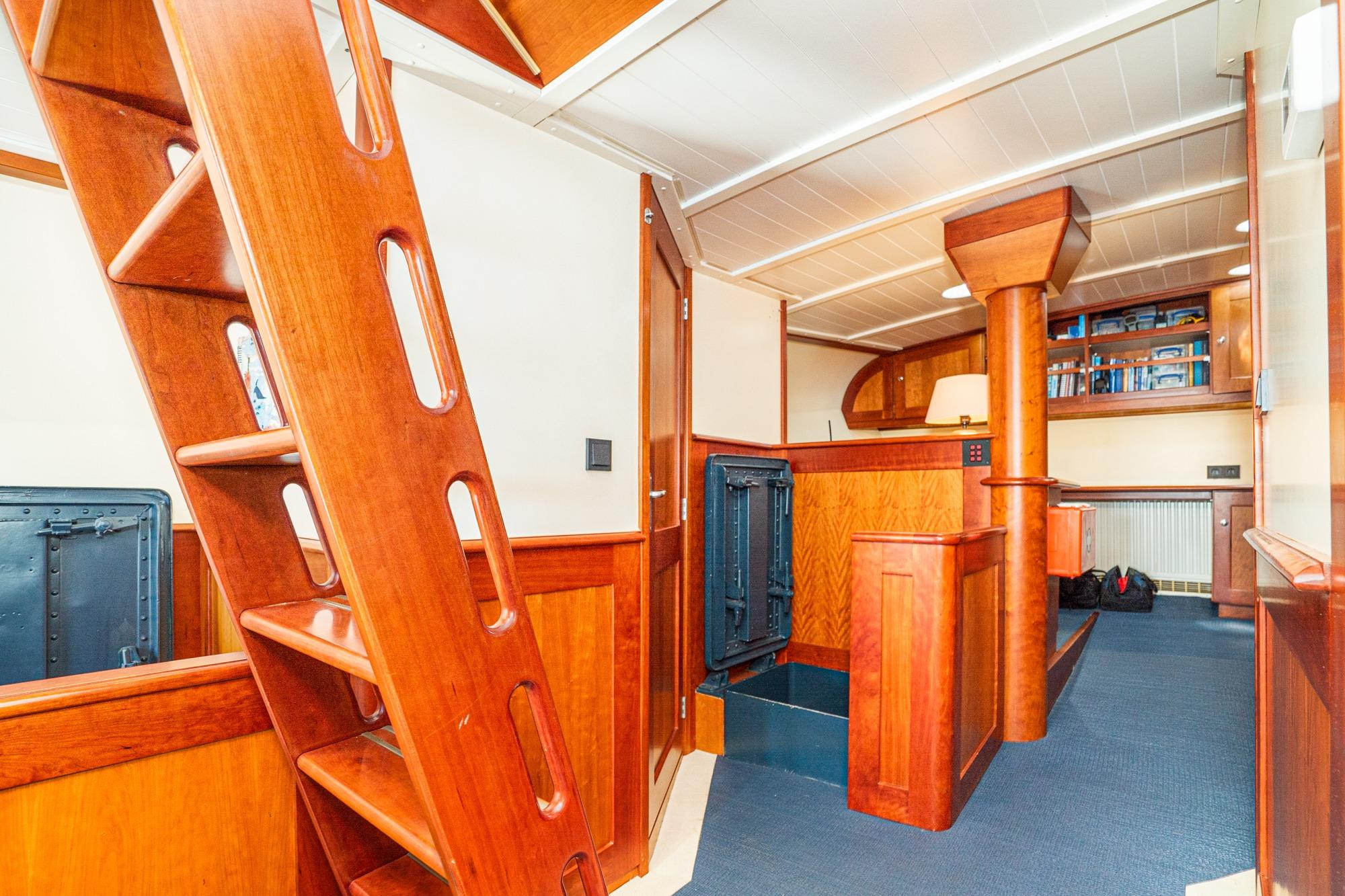 Interior of 1965 Van der Molen Custom boat with wooden ladder and cabinetry.