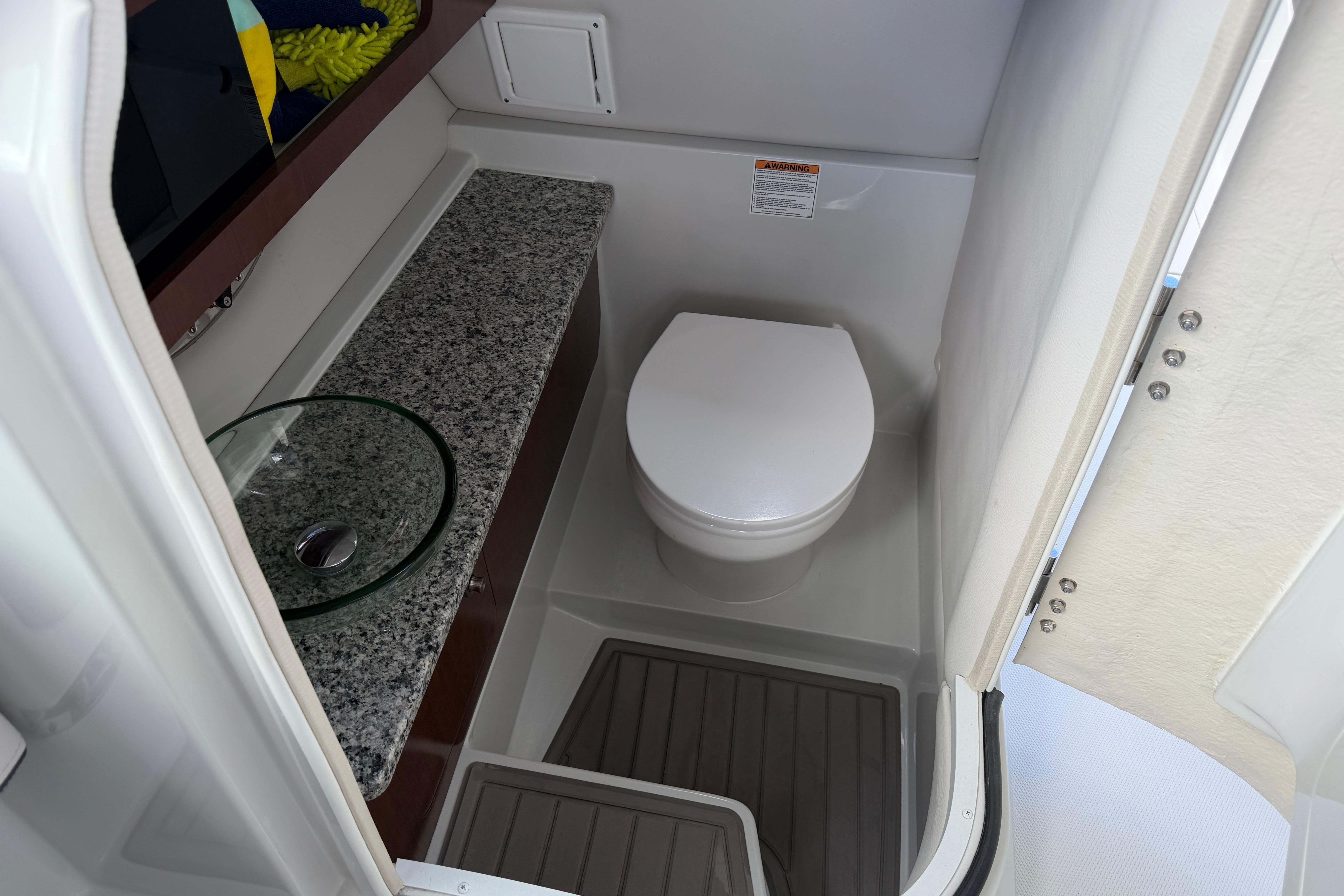 2024 Crownline 260 DC Finseeker boat bathroom with modern sink and toilet.