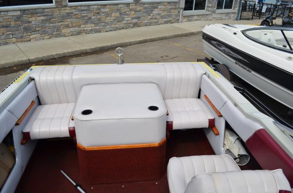 1986 Four Winns Open Bow boat interior with white seating and central table.