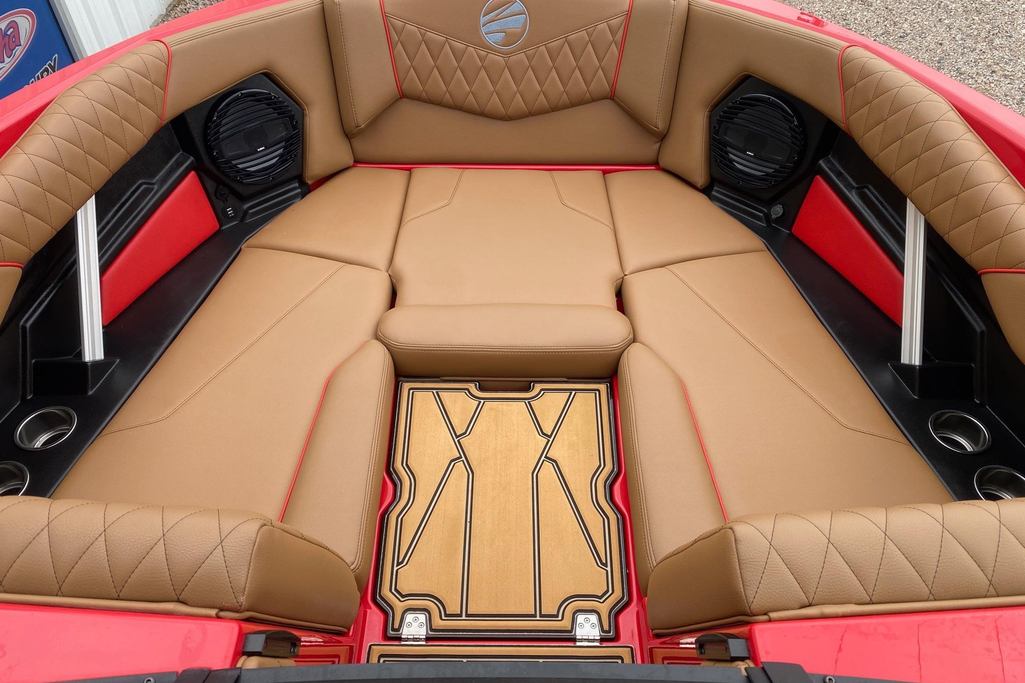 2026 Tigé Z3 boat interior with tan leather seats, red accents, and integrated speakers.