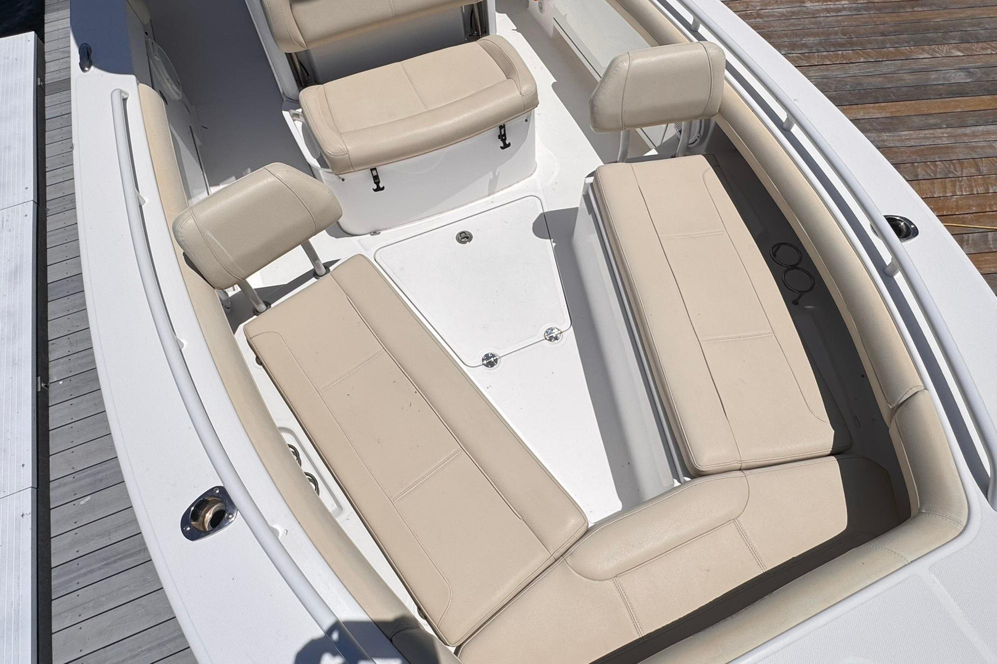 2018 Everglades 253 Center Console boat interior with beige seating and white deck.