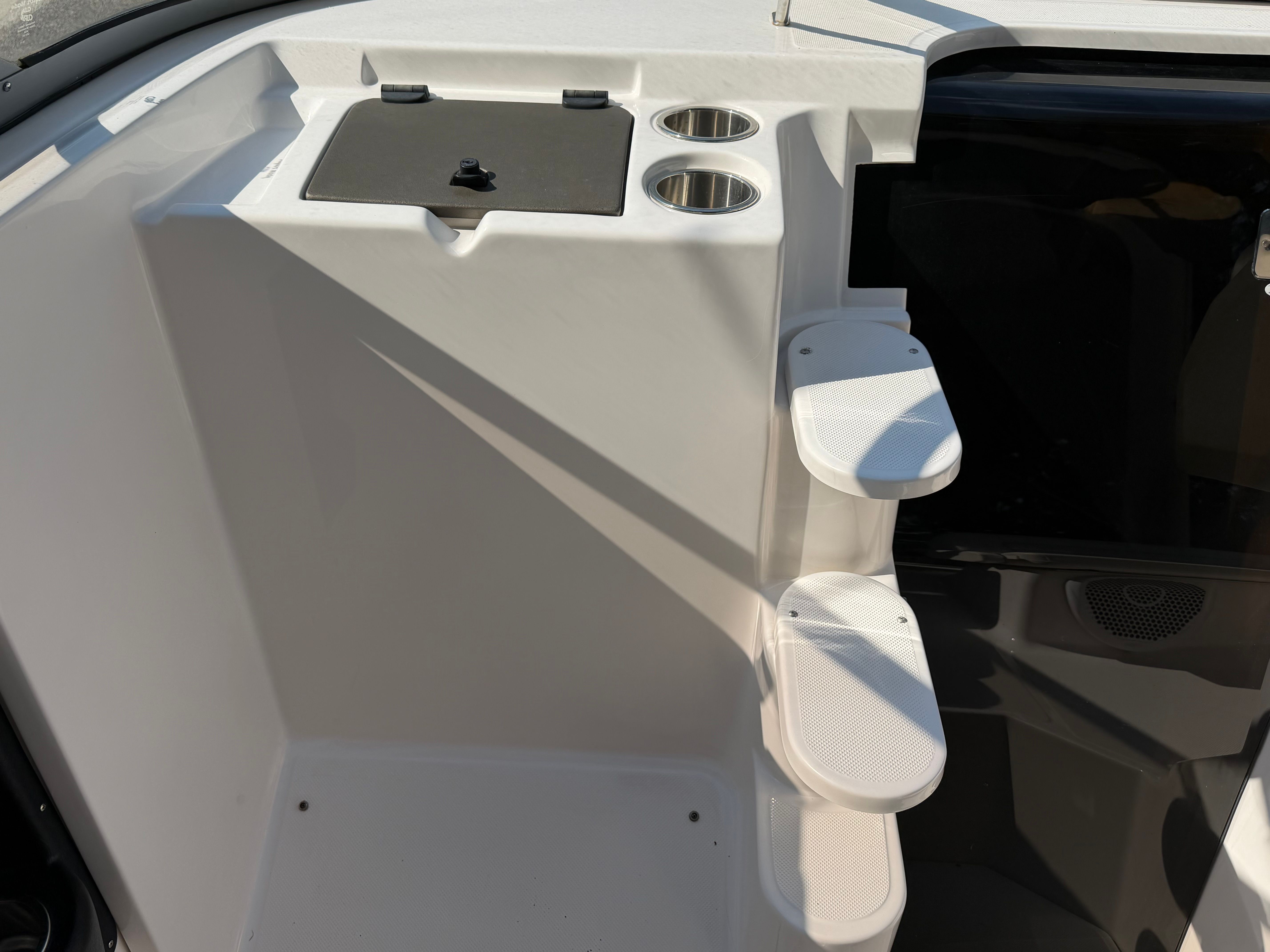 The image shows the entryway of a 2011 Regal 2750 Cuddy with steps and cup holders.