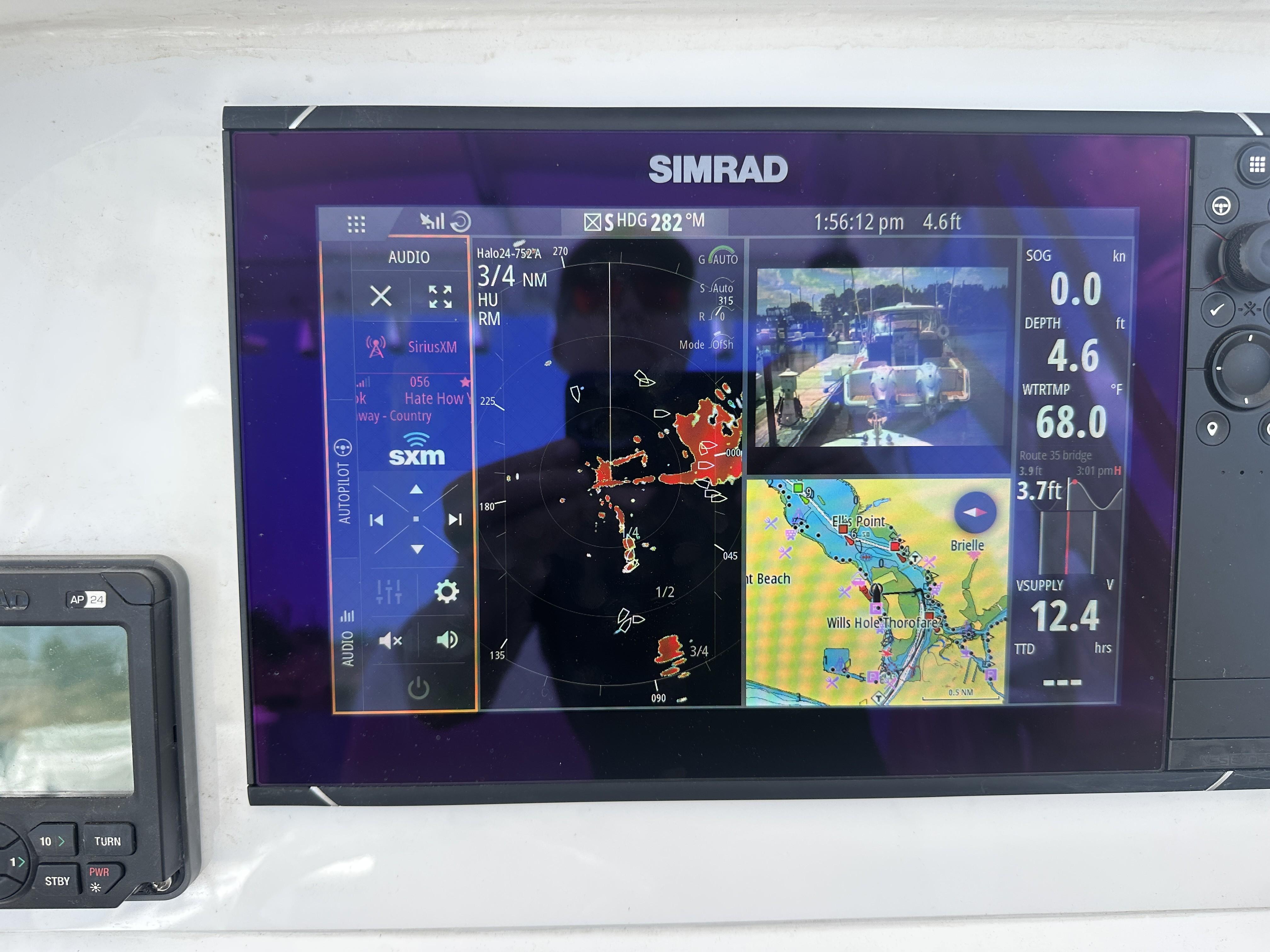 Simrad marine display on 2004 Contender 31 Fish Around, showing navigation and radar data.