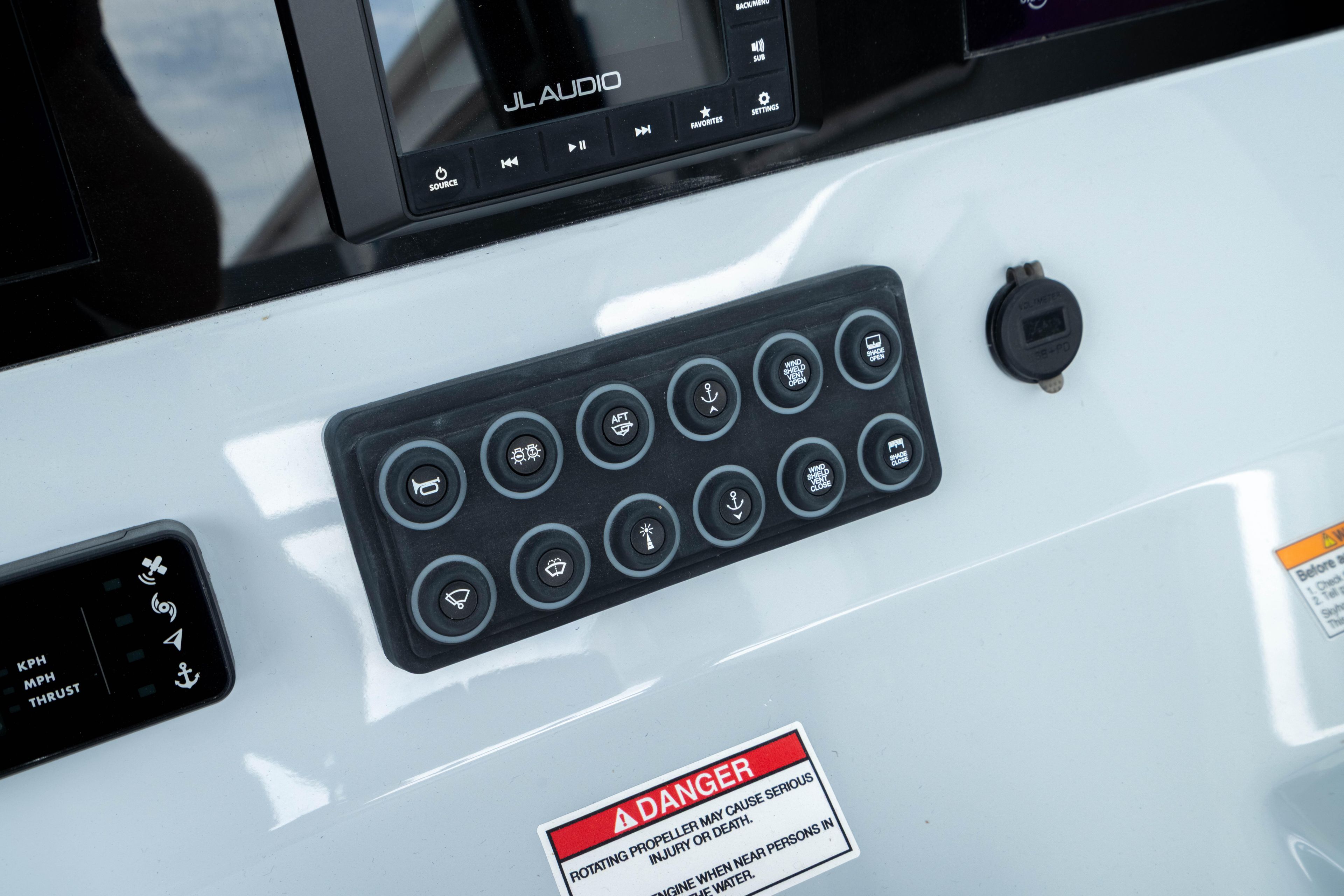 Control panel of 2026 Crevalle 33 CSF boat with various buttons and warning label.
