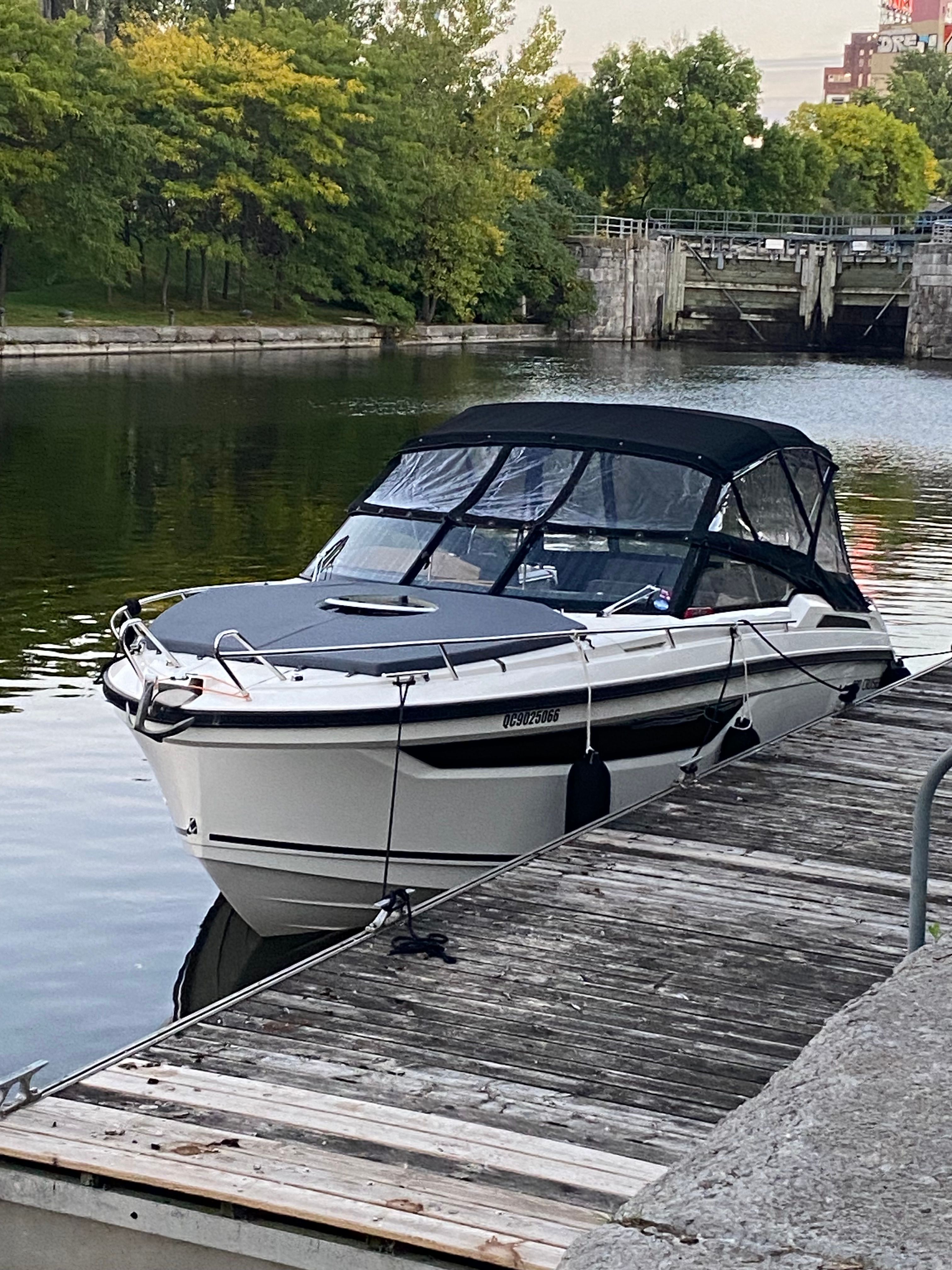 2022 Parker Poland 800 Cruiser docked, surrounded by calm water and trees.