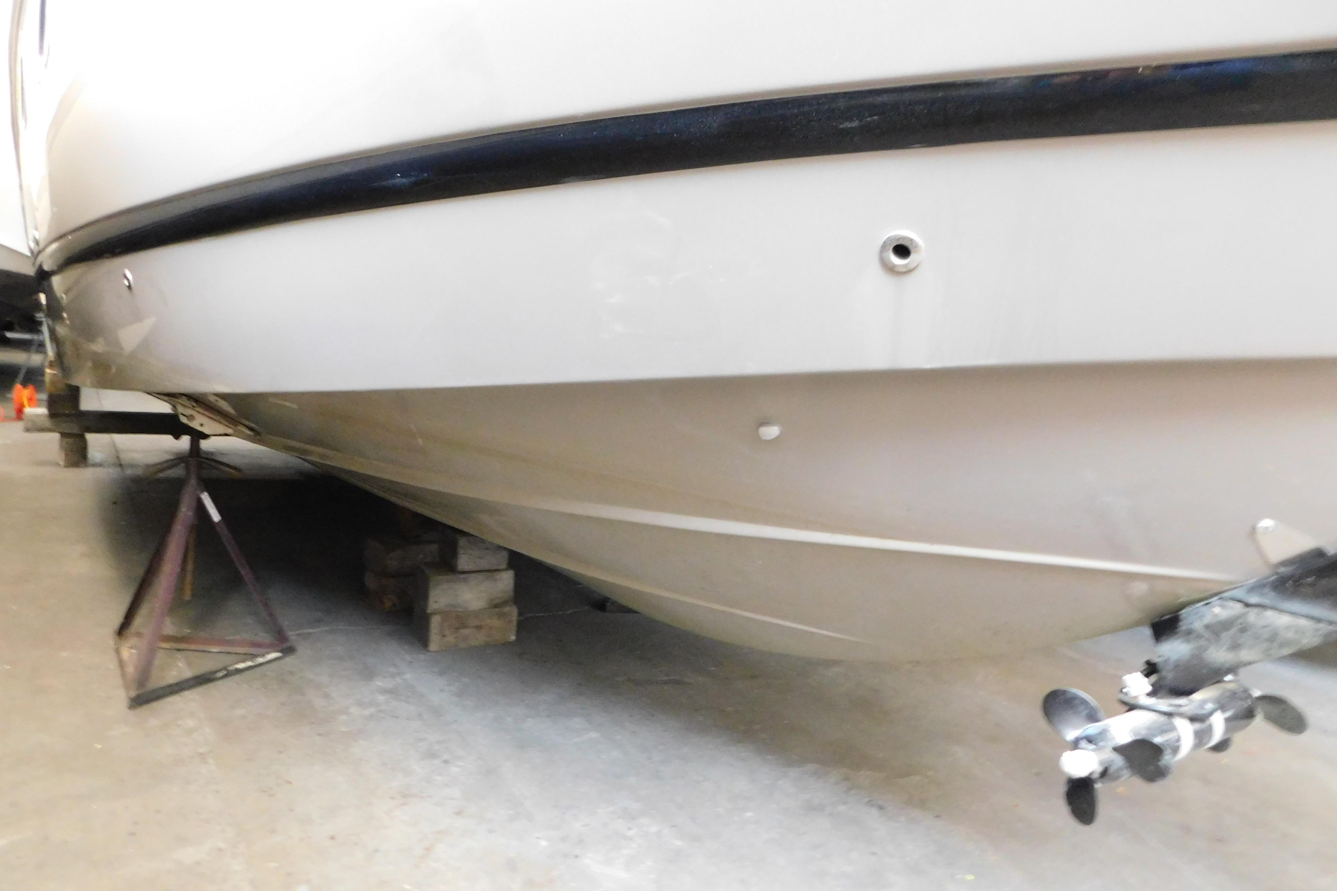 2017 Rinker EX 320 boat hull and propeller in storage.