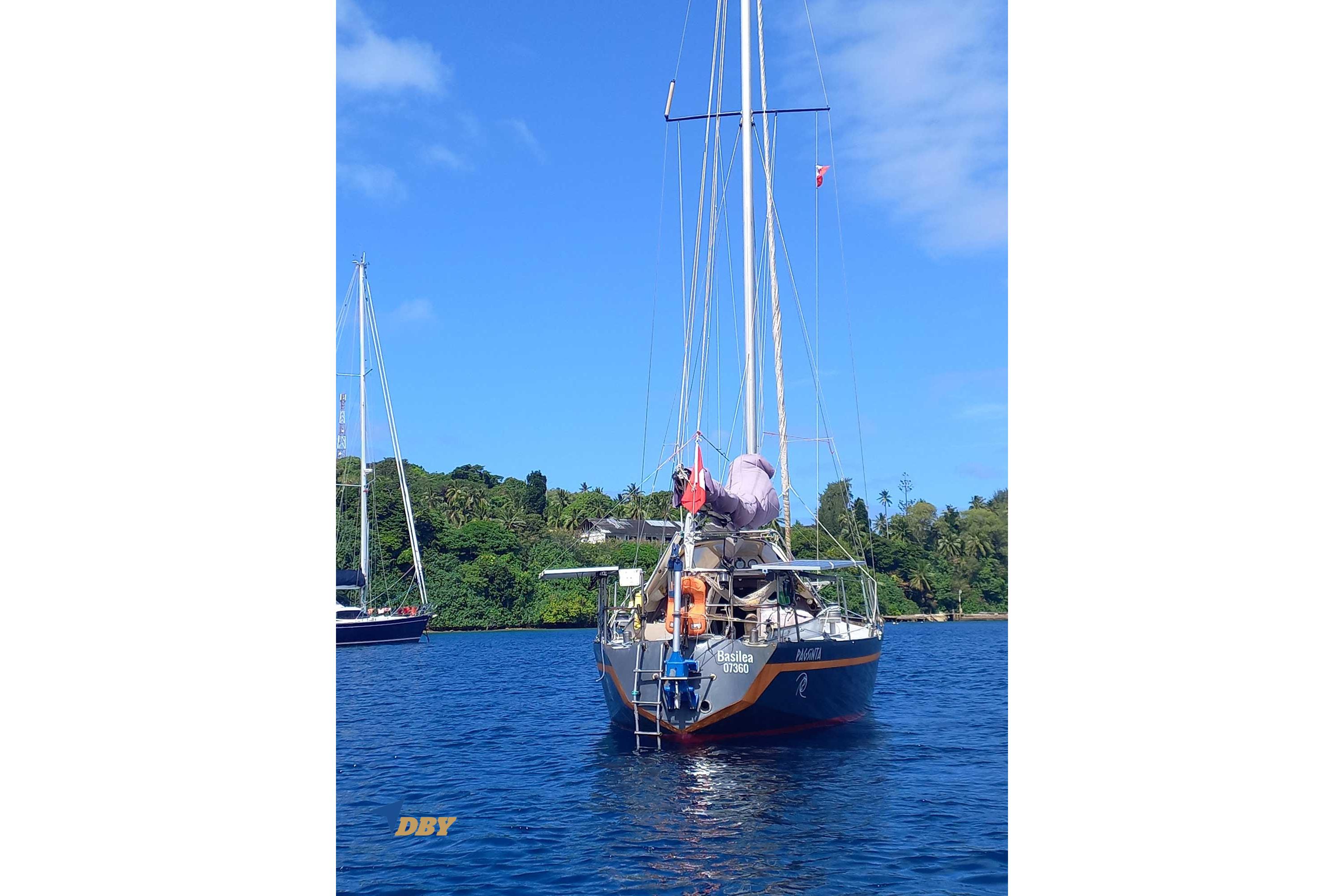Sailboat Reinke Taranga 33, 1982 model, anchored in scenic blue waters.