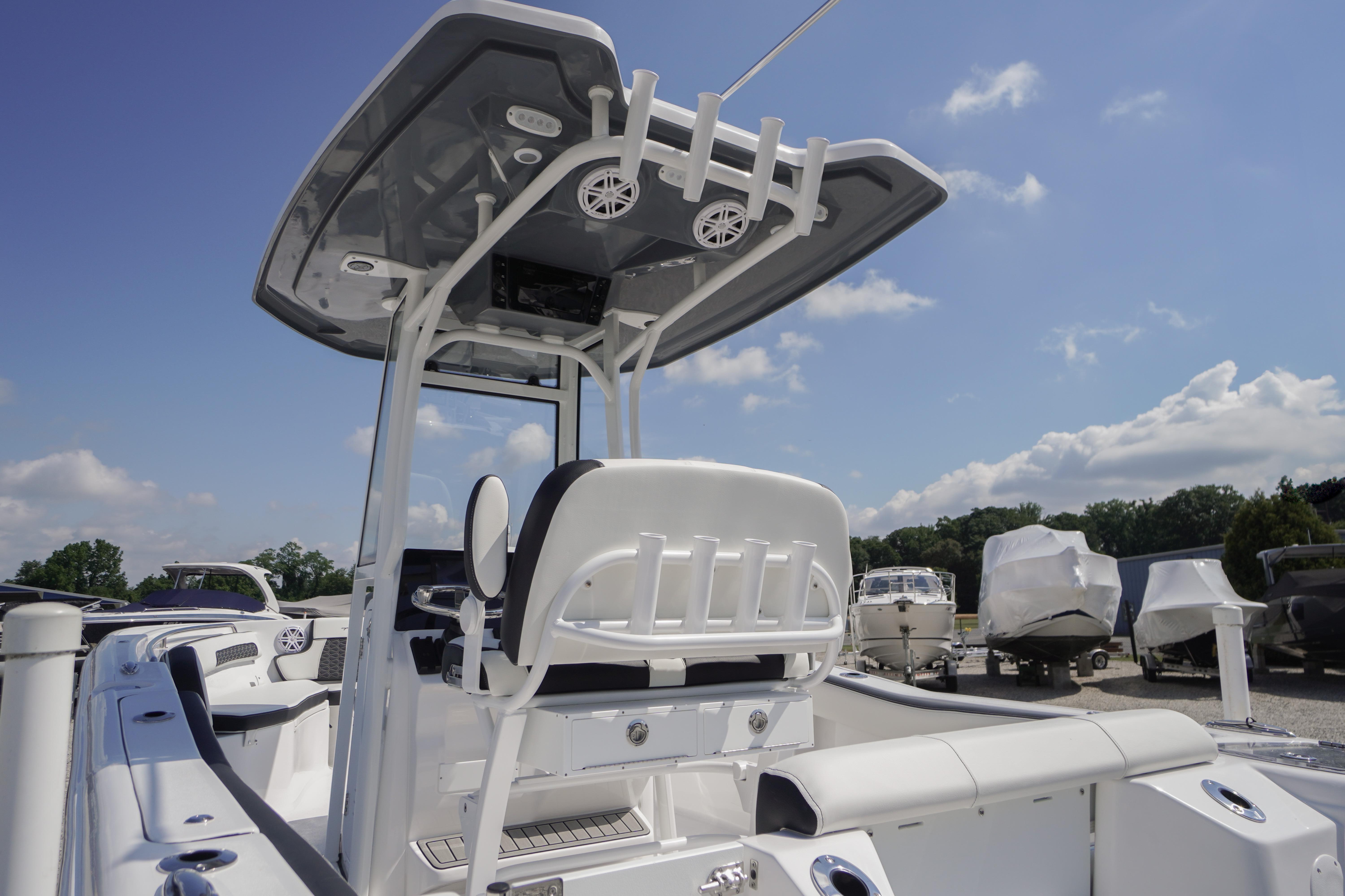 2026 Tidewater 220 CC Adventure boat with T-top and seating, under a clear blue sky.