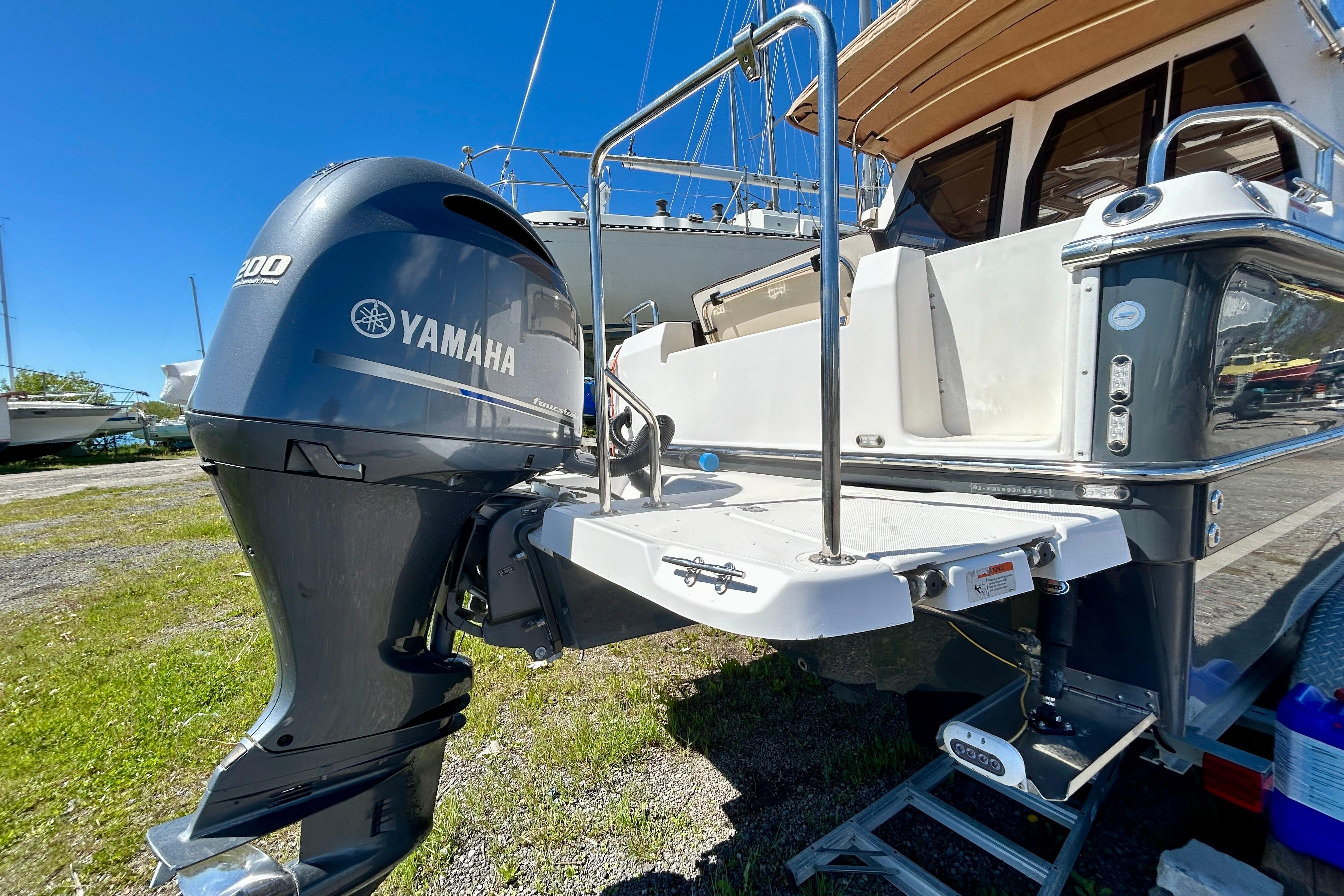 2018 Ranger Tugs R-23 with Yamaha outboard motor, docked on land.