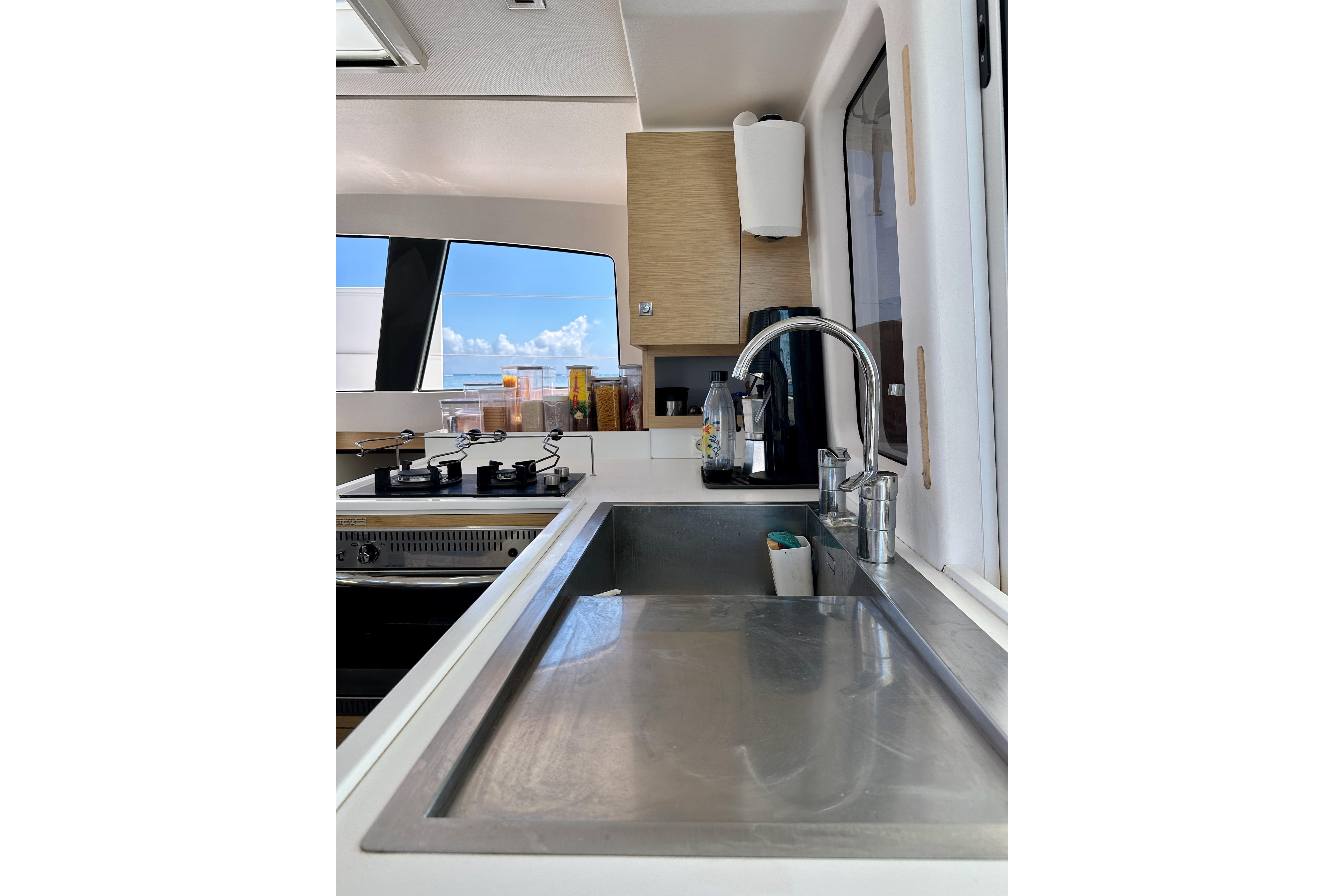 Modern kitchen interior of 2019 Outremer 45 yacht with sleek sink and appliances.