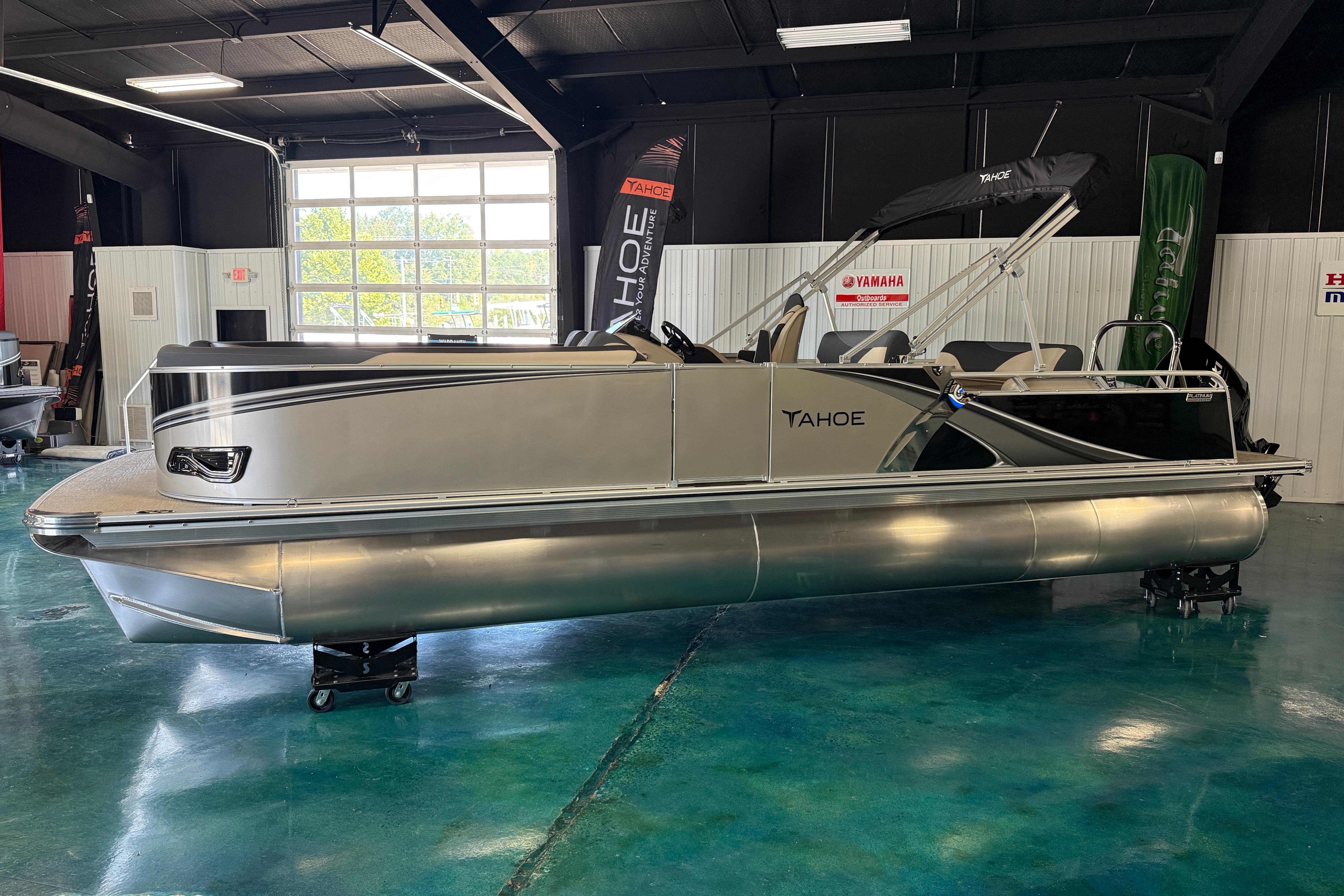 2026 Tahoe Pontoon LTZ Entertainer in showroom, sleek design, modern features.