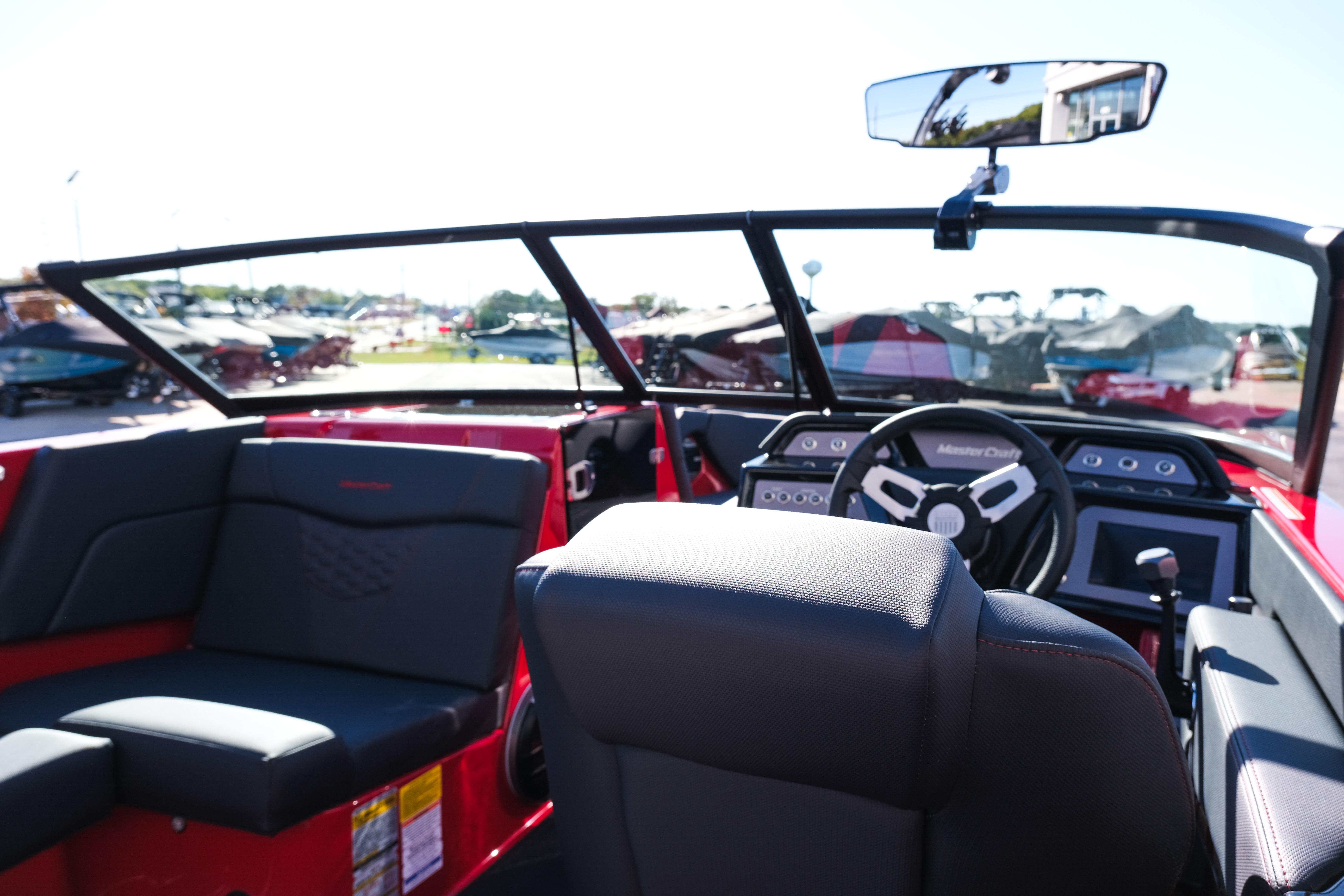 2026 MasterCraft NXT22 boat interior with steering wheel and seating.
