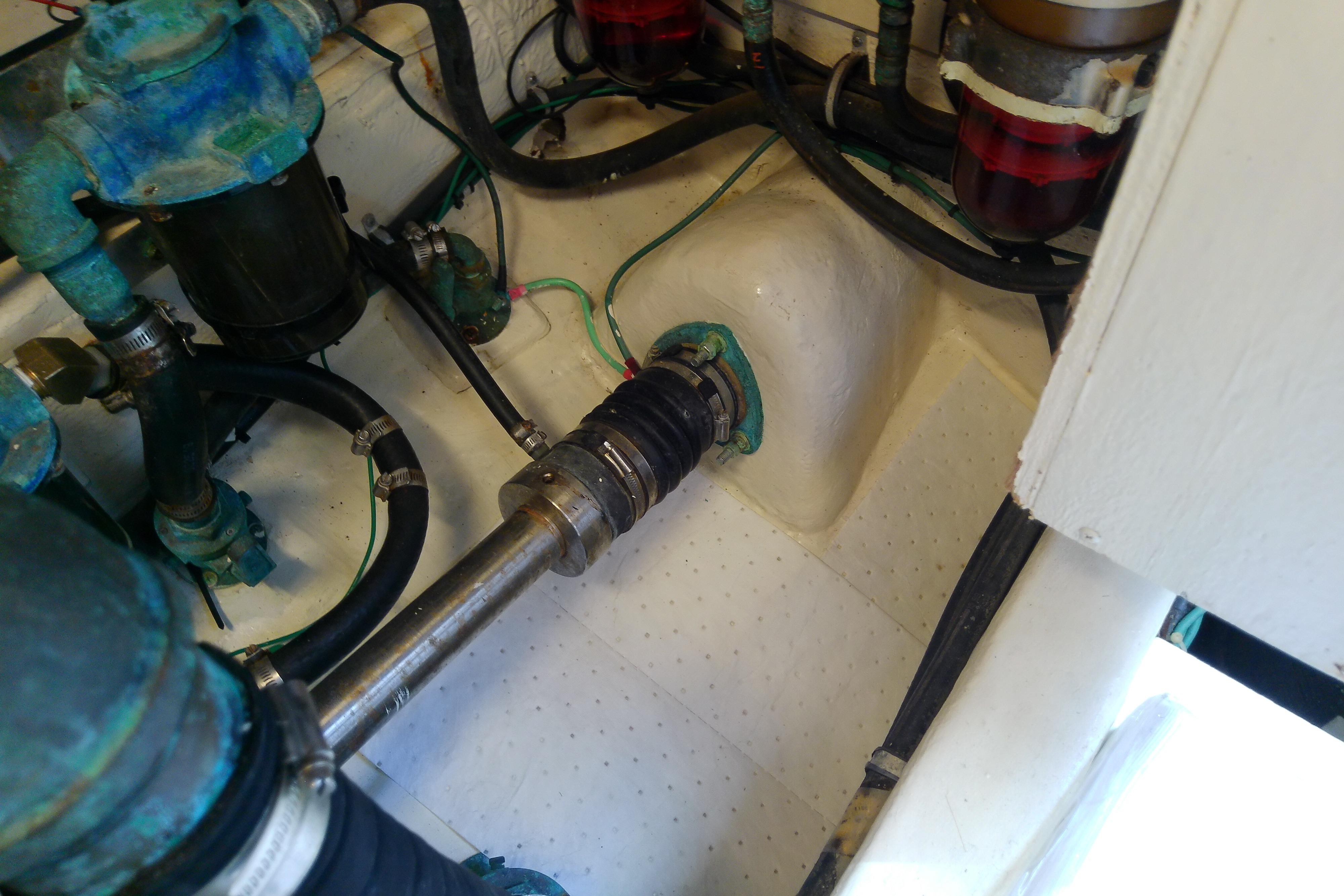 Engine compartment of a 2000 Tiara Yachts 4100 Open, showing mechanical components and hoses.