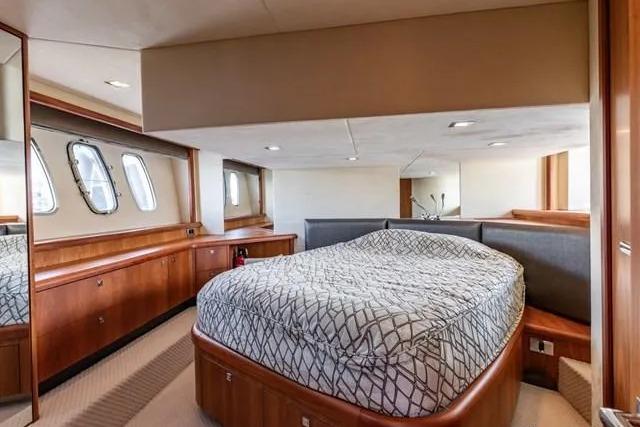 Luxurious cabin interior of 2011 Sunseeker Manhattan 52 yacht with elegant wood finishes.
