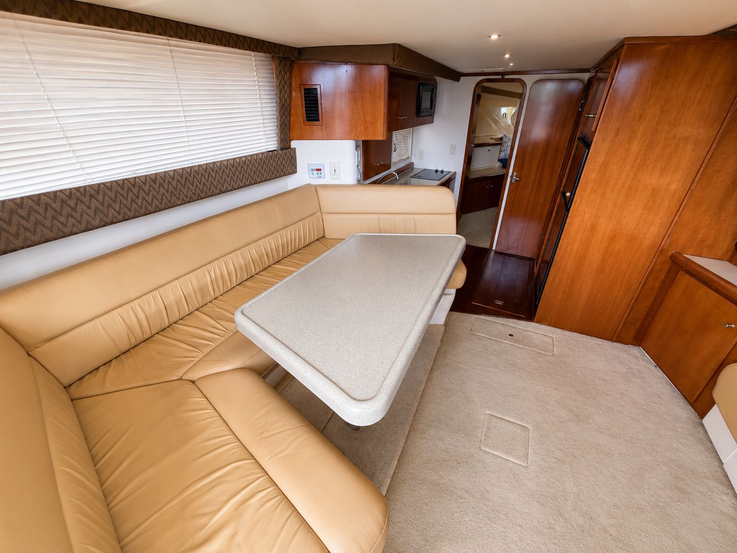 Interior of the 2001 Carver 350 Mariner with beige sofa and table.