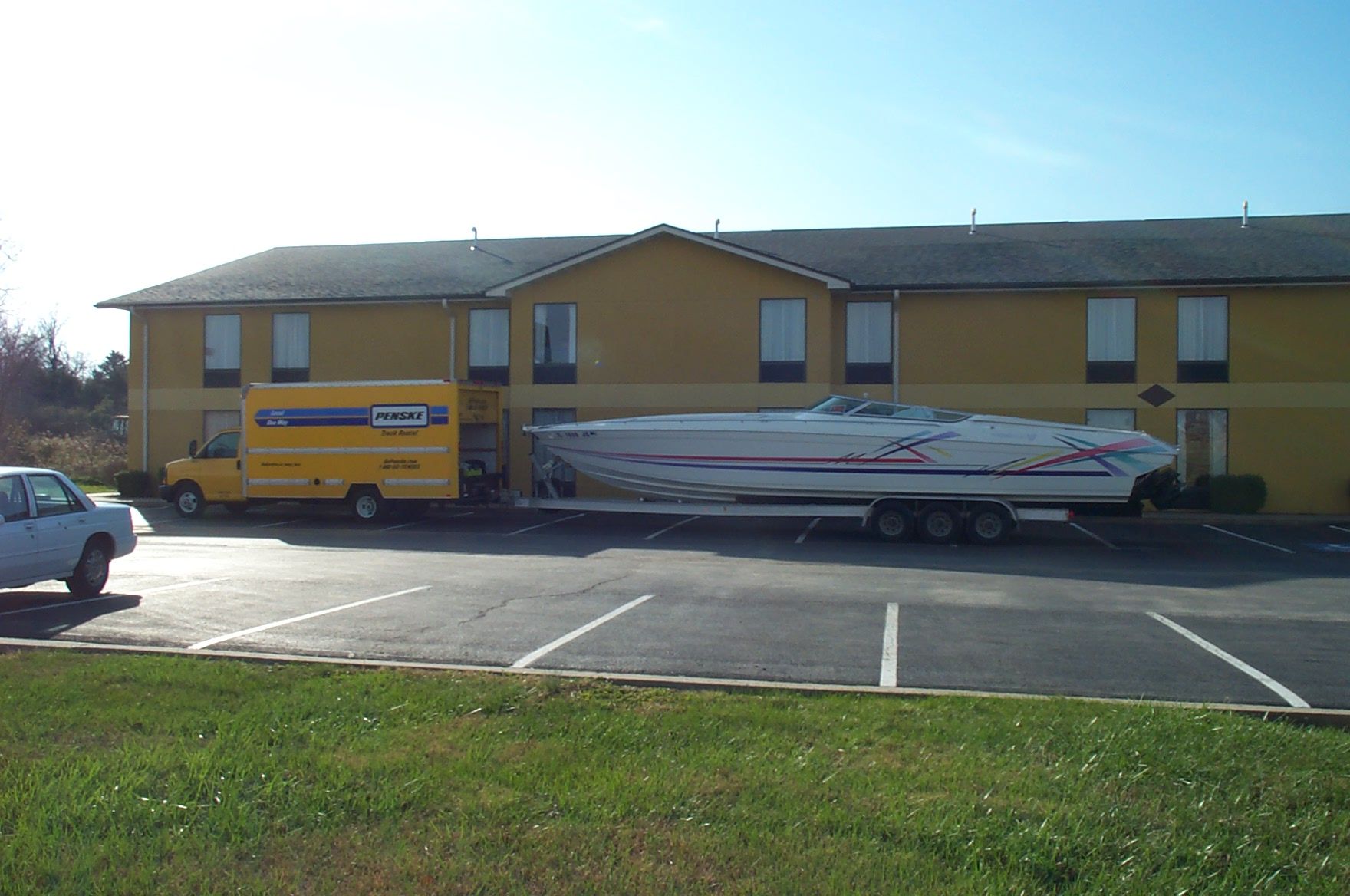 1993 Formula 419 boat on trailer in front of yellow building.