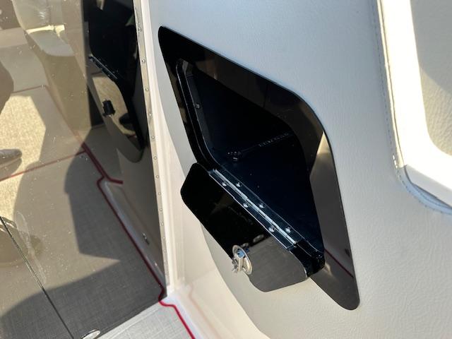 2025 Regal LS9 Surf boat interior storage compartment with sleek black finish.