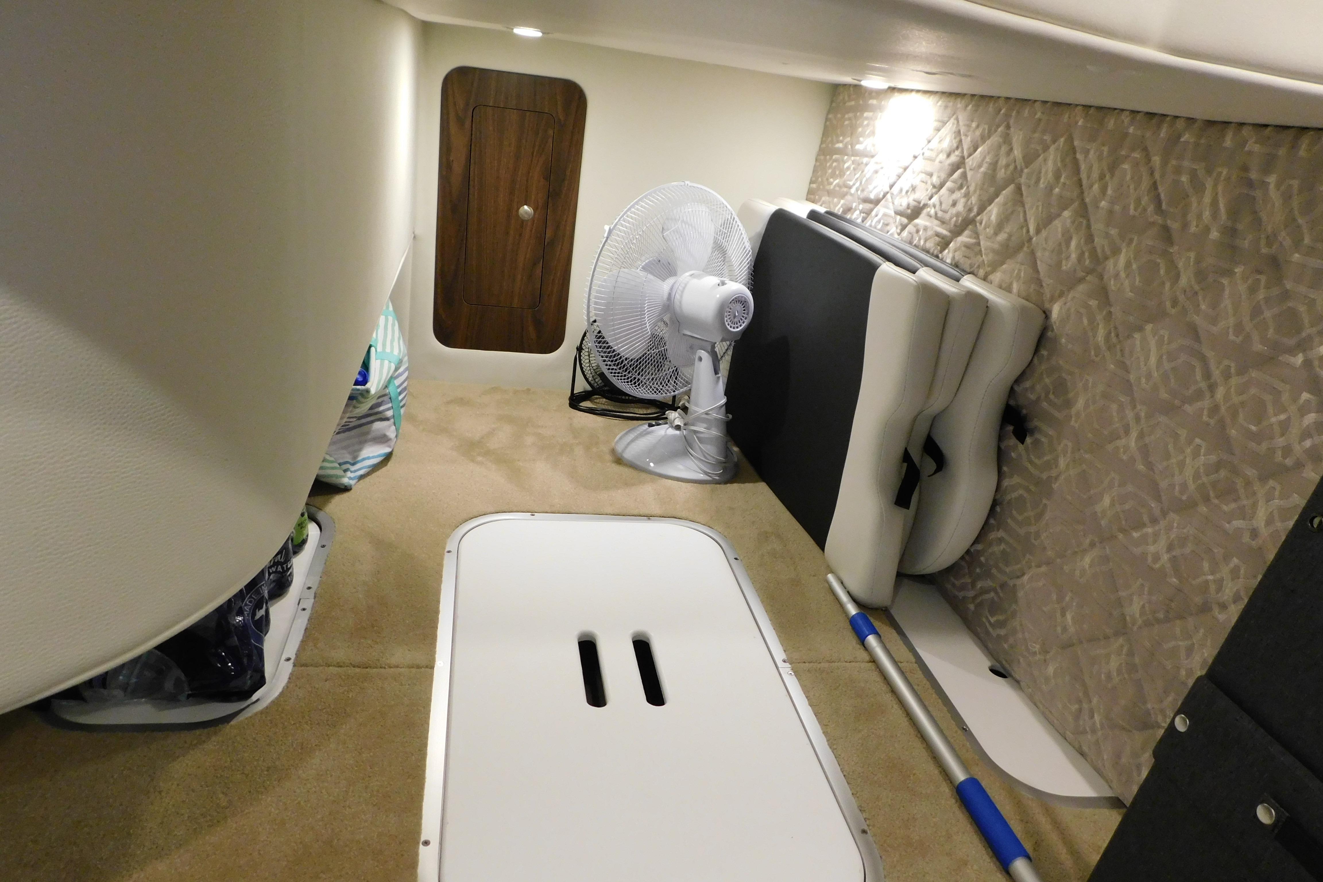 2017 Rinker EX 320 cabin interior with fan and storage space.