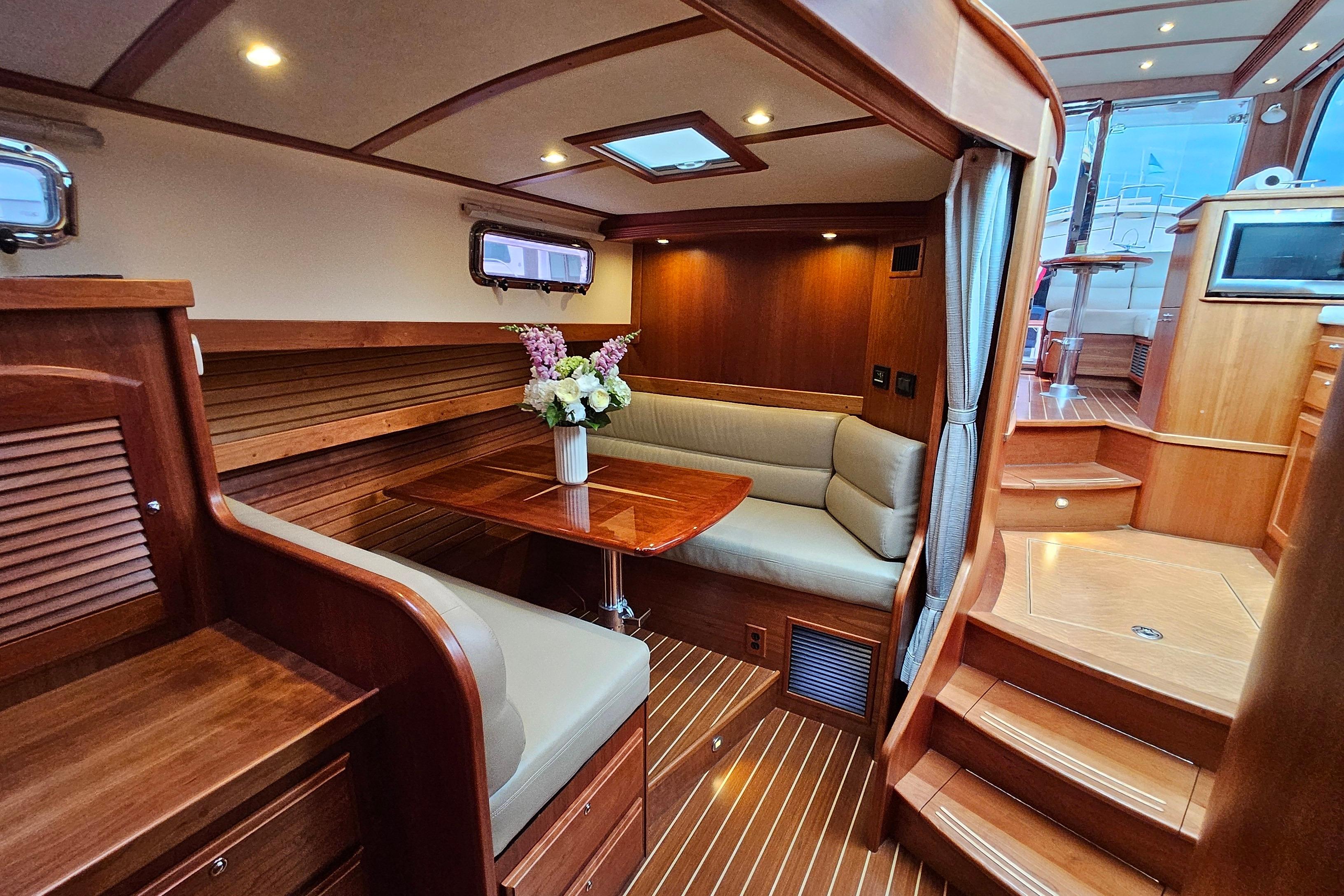 Luxurious interior of 2015 Sabre 42 Salon Express yacht with elegant wood finish and cozy seating.