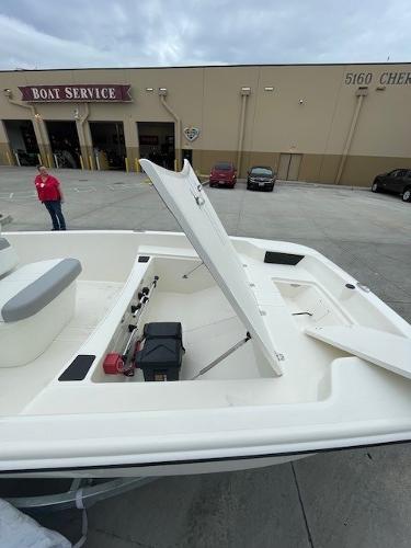 2025 Mako Pro Skiff 17 CC boat with open storage compartment at a service center.